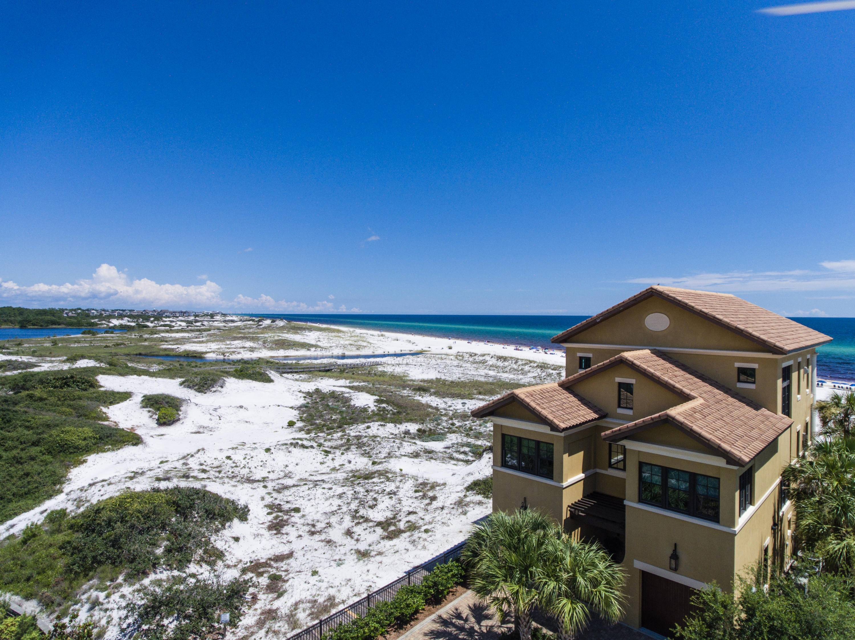 Discover 30A Gulf-front living with unsurpassed privacy and seclusion. 60 Deer Lake Beach Drive is a rare and exceptional Gulf-front estate, boasting 3/4 of an acre with 1.5 miles of open beach to the east for the ultimate privacy. This beach estate provides serenity like no other. An extraordinary location bordering award-winning Deer Lake State Park, offering approximately one and a half miles of unobstructed Gulf views to the east overlooking the coastal dune lake of Deer Lake all the way to WaterSound Beach. Deer Lake State Park sits as your direct eastern border neighbor, occupying one half mile of Gulf frontage that will never be built upon and the full mile of private community beach of WaterSound Beach follows. The custom-built beach home was designed by renowned architect Walt