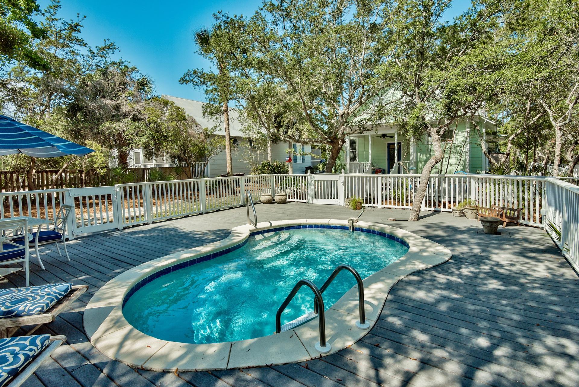 Beside having a gorgeous Private Pool, you can also walk or ride to the beach from this charming beach home that is less than half a mile to the beach. 3 bedrooms and 2 bathrooms and a loft with french doors opening to screened balcony for perfect sunset viewing.Outdoor shower, plantation blinds,8 ceiling fans. Private view in front of home that is green space, with deeded beach access. Gulf Shore Manor is a small neighborhood on a quiet sandy street off of San Juan and Barcelona. Truly one of the last great streets in Seagrove to own on. Sold furnished and has an open concept living/dining/kitchen. The pool area off the back has a large deck to sun on. Rental projections close to $60,000 Parking available at the beach access for Golf Carts, Bikes and cars. Gulf Shore Manor! Walk to the Beach - Neighborhood beach access with bike rack, golf cart and automobile parking available! Seagrove Beach is one of the most popular spots on 30A!
This private street that has green buffer space in front of the home and a large private pool makes for the perfect rental property.