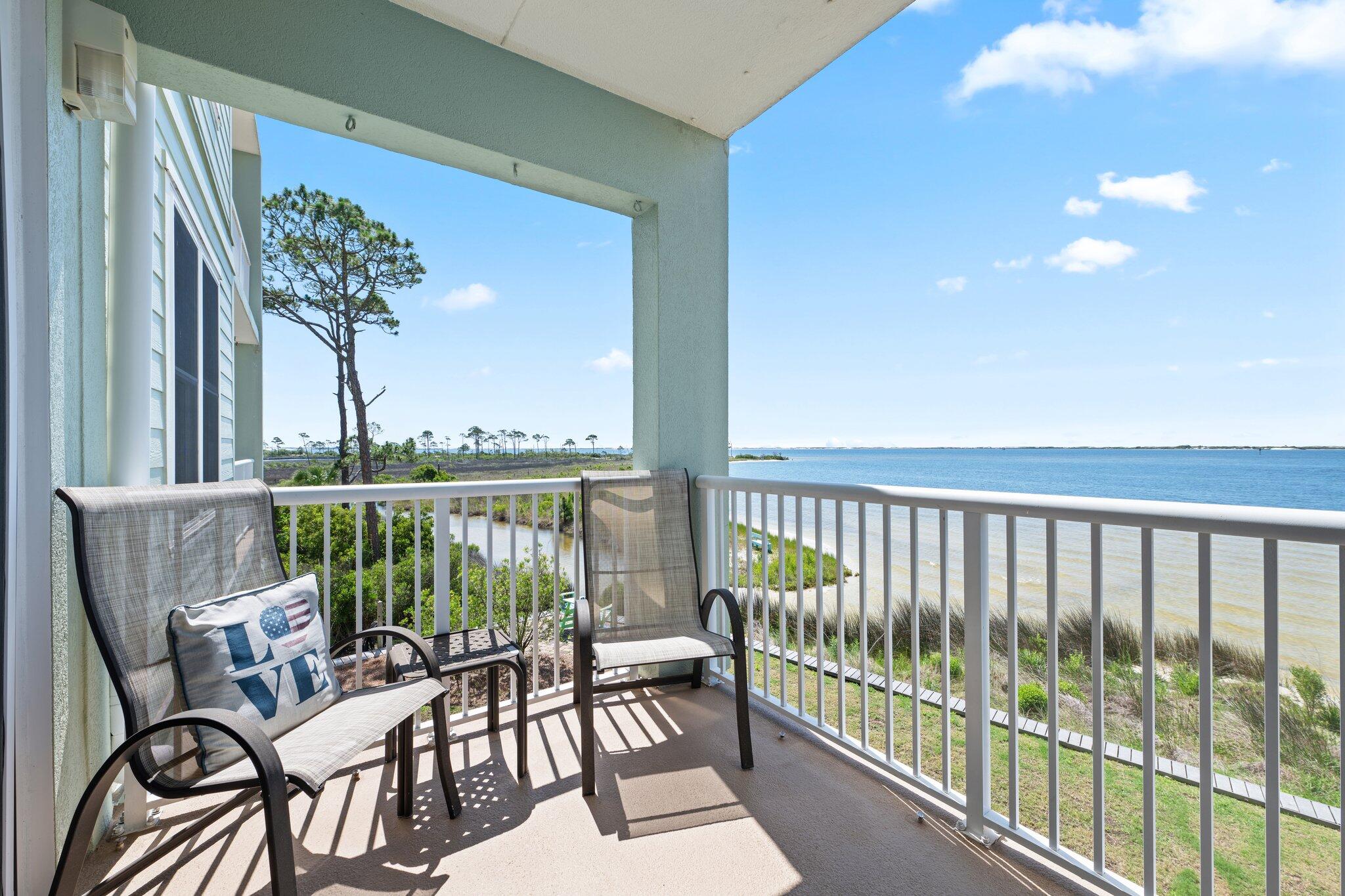 DIRECT WATERFRONT 3-bedroom, 2-bathroom in the gated community of Laguna Pointe. Building 4050 Indigo has direct waterfront views of Big Lagoon waterway where you can watch boats, jet skis, dolphins and the Blue Angels regularly fly by! The balconies of this building are not shotgun views, rather boast multiple views of the water. Inside is a split bedroom design with the guest bedrooms at the front of the unit. One guest bedroom has a walk-in closet. The spacious master bedroom has its own sliding door with stunning views of the intercoastal waterways. The large master attaches to a 5-piece master bath with a jacuzzi tub, separate walk-in shower and dual sinks. The master bedroom has a walk-in closet with built in shelves and drawers. Enjoy entertaining in the spacious kitchen/living/dining combination with loads of white cabinets and tile countertops. No carpet in this unit..ceramic tile flooring throughout. The large separate laundry room with pocket door provides additional storage. Outside there is covered tandem parking for two vehicles and an 8x5 storage unit for beach toys. Enjoy the sunshine in the outdoor pool or fishing on the large pier. The complex provides kayak storage and a kayak launch. This unit comes with all appliances including the washer and dryer and is also partially furnished. Exterior roof and painting were completed 2021. HVAC unit is 2021 and Water Heater is 2016. Rentals are restricted to 3 month terms allowing for a peaceful, exclusive environment. Less than 5 miles to the Naval Air Station and to the sugar white beaches of Perdido Key, this is a great place to call home! Sold fully furnished except for a couple of personal items.