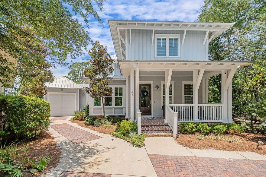 Forever green space and an enviably close location to the beach set this characterful custom home apart from the rest. Positioned on a premium lot abutting Point Washington State Park, this attractive residence boasts a brick-paved front porch and additional parking in the driveway. Adjacent to the garage, there's a handy mudroom with front and rear access, built-in cabinets and a sink. Step inside the airy main living space where the quality materials and craftsmanship are immediately apparent. Gleaming hardwood floors, 10-ft. ceilings and abundant natural light grace the sitting area. A cozy gas fireplace and built-in bookshelves lend a sense of togetherness. The oversized dining area is sure to be the hub for family celebrations and memorable entertaining.