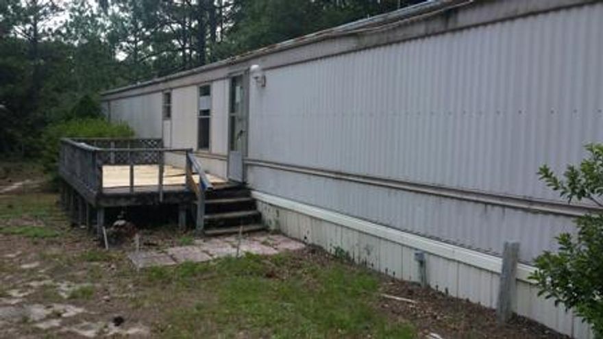 3 bedroom, 2 full bath mobile home situated on a large forested lot of over 4.5 ACRES! Living room with corner fireplace. Master bathroom with garden tub and his/her vanity. Electric stove in kitchen. Large open front deck. Two yard/storage sheds. Beautiful, private lot at an unbeatable price!