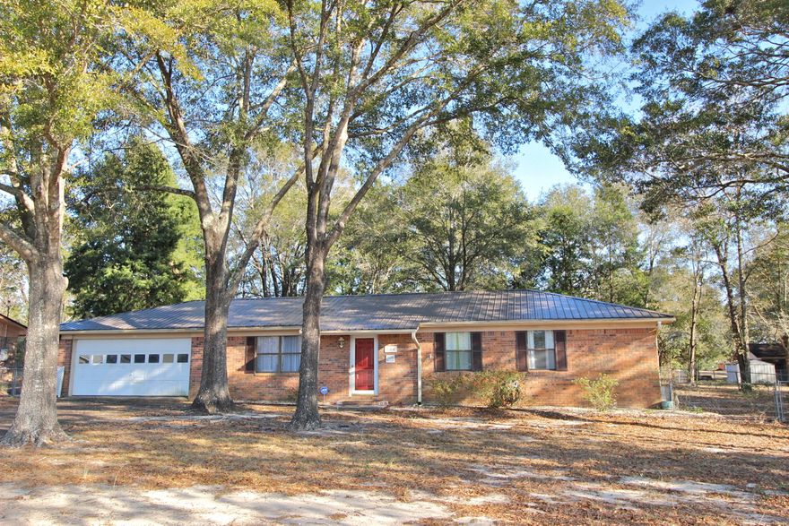 All brick home across from Back Lake with pretty water views! Open kitchen, dining and living room with large, bright, heated & cooled sunroom that leads you to the screened back porch. Located on a shaded & fenced lot with mature trees, this home offers a new metal roof and new windows as well as a 2 car garage. Also a large laundry room with room to hang clothes or extra storage! Home is in an estate and will be updated with more pics by the beginning of February (after all contents are removed). Home being sold As Is with right to inspect, only because the seller has limited knowledge of the home. Price reflects that and the condition - and the cosmetic updates a buyer may want after closing such as paint and flooring. You could easily have some sweat equity on this one!