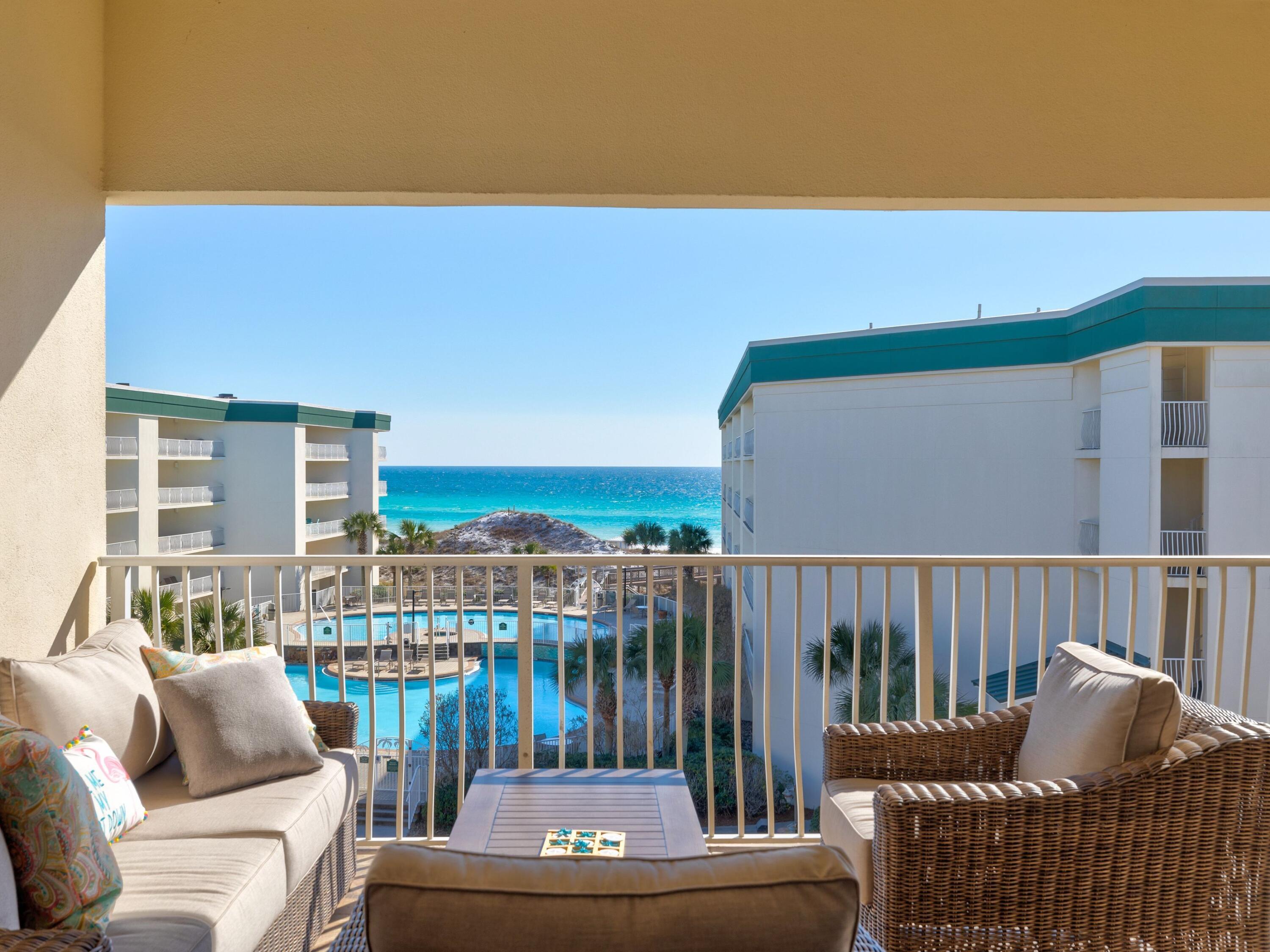 Presiding over the white sandy beach at Dunes of Seagrove, this top-floor condo enjoys shimmering gulf views. From the underground parking space in the covered garage to the generous balcony, it's a carefree vacation home or investment rental. Wood flooring flows from the entrance hall throughout the entire condo, complemented by soft sea shades in the decor and accents. The light, open living area has new furniture in neutral tones, while the monochrome kitchen has gleaming black granite counters and stainless steel appliances. Four stools are lined up at the bar for breakfast pancakes or drinks before dinner. A separate laundry closet hides the stacked washer and dryer. Move into the open living space where three sets of floor-to-ceiling windows frame superb gulf views. They provide seamless access to an oversized balcony, which is furnished with lounge chairs, a deep cushioned outdoor sofa and a table for alfresco dining in the fresh sea air. The master bedroom also has direct balcony access, delivering beautiful gulf views to start the day. The master bath boasts a swirling spa tub, a smart twin vanity and separate walk-in shower. There's a second bedroom and bathroom with shower over the tub. Extra guests can be accommodated in the custom-built queen bunk bed with twin trundle. All new mattresses, a new master headboard and lighting are complemented by fresh paint and brand-new towels and linens. It's totally turnkey. With twin pools, a hot tub, sauna, fitness center, bicycles and tennis courts, there's plenty to keep you busy without leaving the well-maintained resort. A boardwalk carries you over the dunes to the sugar-white sand, where a beach chair service is available from March to October. Located between Eastern Lake and Deer Lake, you're within easy reach of walking trails, coffee shops and seafood restaurants, as well as shopping and entertainment at The Big Chill. It's 30A living at its best.