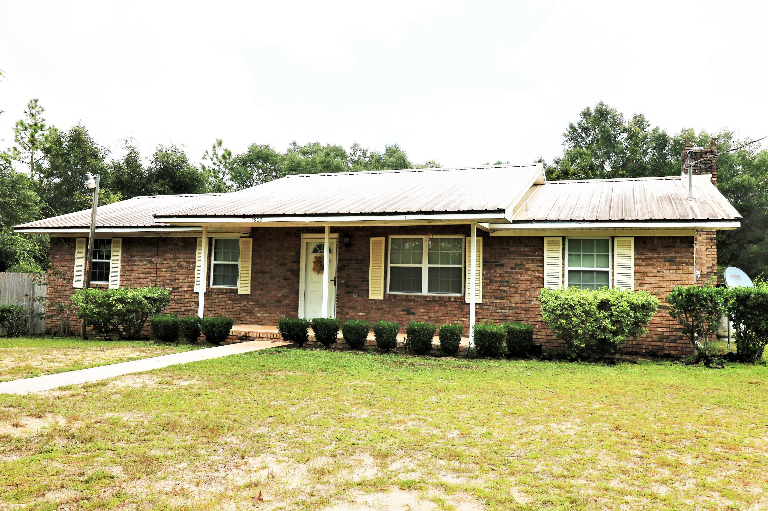 Lovely home or possible commercial venture! Corner location has great commercial potential with 170 feet on HWY 77 and 285 feet on Pettis RD. Home faces HWY 77 which will be a four lane HWY in the DOT plan. Commercial Class 2 zoning. Features include: Newer metal roof, windows, and interior and storm doors. The kitchen and bathrooms have been lovingly updated and master bedroom has full bath, 8 ft closet, and additional closet. Family room has a gorgeous brick fireplace with gas logs. Bonus: 20 x 30 detached garage/workshop. All this on 1.8 acres! Property is situated approximately 11 miles from interstate 10, 13 miles from Falling Waters State Park, 38 miles to the International Airport and sugar white beaches of Panama City Beach, and 7 miles from Washington County Reception Center.