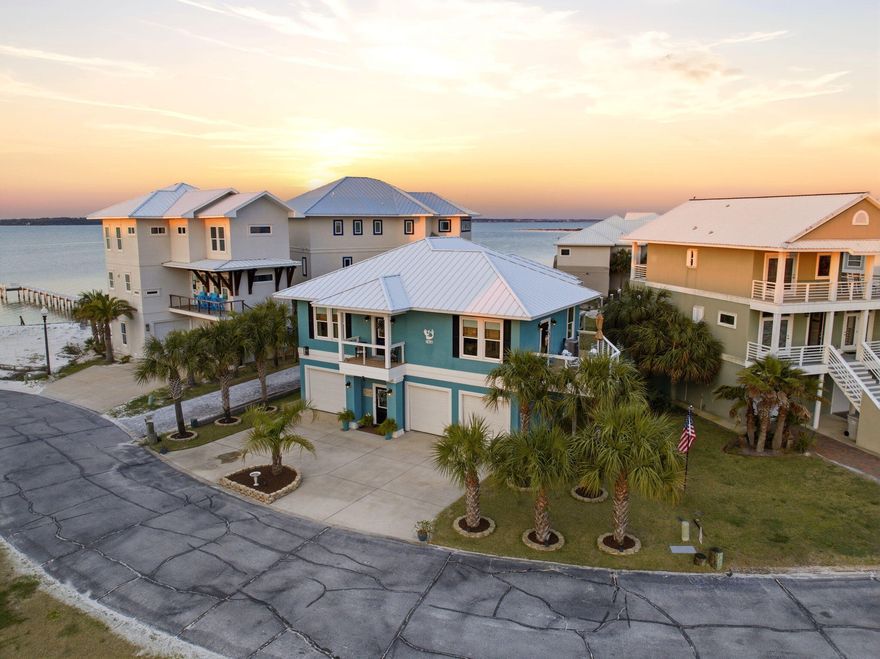 Welcome to Your Private Coastal Sanctuary in Caribbean Isle on Navarre BeachFrom the moment you enter the exclusive, gated community of Caribbean Isle, you're transported into a true tropical paradise--complete with winding roads, vibrant coastal architecture, underground utilities, streetlights, and resort-style amenities including a community pool and tennis courts.Perfectly positioned in one of the most desirable locations within the neighborhood, this custom-built, one-owner beach home offers the ultimate blend of privacy, convenience, and luxury. Just steps from your back door, you'll find direct access to the sugar-white sands and emerald waters of the beach. Enjoy peaceful morning strolls along the quiet shoreline, or head just across the street to experience the energy of Gulf. Designed for Coastal Living & Entertaining

This thoughtfully designed residence features four spacious sleeping areas, including a custom bunk room with built-in beds and storage--perfect for hosting family and guests. Every inch of this home reflects intentional design and elevated coastal style.

The main living spaces are pouring with natural light, enhanced by expansive windows and three generous porches that capture both sunrise and sunset views. With water views from nearly every angle, the connection to the coast is felt throughout the home.

The chef's kitchen is a true showpiece, featuring ceiling-height light blue cabinetry, upgraded countertops, designer sconce lighting, and an open layout ideal for entertaining.

Exceptional Features Inside & Out

Impact-rated glass for enhanced durability and lower insurance costs

Luxury vinyl plank flooring with a soft driftwood finish

Custom cable railing on decks for unobstructed water views

Metal roof for long-term durability

Deep soaking tub and designer tile shower in the primary suite

Abundant storage throughout, including a space designed for a future elevator (plans available upon request)

Ground Level Coastal Retreat

The lower level offers an incredible flex space--ideal for a den, game room, or "man cave"--featuring a unique glass garage door that allows natural light to pour in while maintaining privacy. Just outside, a private outdoor shower provides the perfect spot to rinse off after a day at the beach. (This was not added into the upstairs square footage.) 

With over 1,600 square feet of garage space, there's ample room for multiple vehicles, golf carts, and all your beach and boating gear.

Outdoor Living at Its Finest

The professionally enhanced landscaping, complete with multiple palm trees, perfectly frames the home and enhances its tropical curb appeal. Every outdoor space invites relaxation, from breezy porches to shaded areas below.

Additional Highlights

Located in the gated community of Caribbean Isle

Low HOA: $485/quarter

Flood Insurance: ~$996/year

Homeowners Insurance: ~$3,700/year

Furniture negotiable with acceptable offer

This meticulously maintained home offers not just a residence, but a lifestyle--where every day feels like a vacation.

Experience the beauty, comfort, and luxury of Navarre Beach living in Caribbean Isle. Schedule your private showing today.
