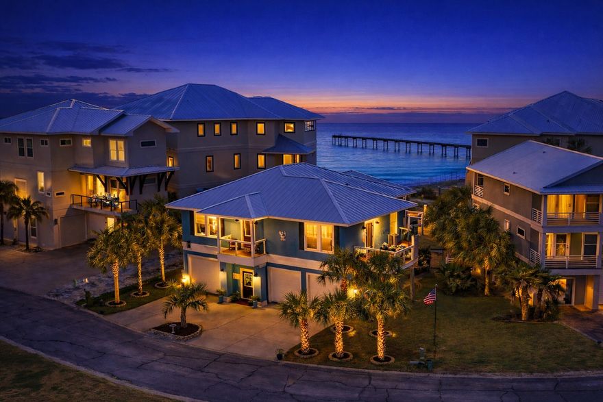 Welcome to Your Private Coastal Sanctuary in Caribbean Isle on Navarre BeachFrom the moment you enter the exclusive, gated community of Caribbean Isle, you're transported into a true tropical paradise--complete with winding roads, vibrant coastal architecture, underground utilities, streetlights, and resort-style amenities including a community pool and tennis courts.Perfectly positioned in one of the most desirable locations within the neighborhood, this custom-built, one-owner beach home offers the ultimate blend of privacy, convenience, and luxury. Just steps from your back door, you'll find direct access to the sugar-white sands and emerald waters of the beach. Enjoy peaceful morning strolls along the quiet shoreline, or head just across the street to experience the energy of Gulf. Designed for Coastal Living & Entertaining

This thoughtfully designed residence features four spacious sleeping areas, including a custom bunk room with built-in beds and storage--perfect for hosting family and guests. Every inch of this home reflects intentional design and elevated coastal style.

The main living spaces are pouring with natural light, enhanced by expansive windows and three generous porches that capture both sunrise and sunset views. With water views from nearly every angle, the connection to the coast is felt throughout the home.

The chef's kitchen is a true showpiece, featuring ceiling-height light blue cabinetry, upgraded countertops, designer sconce lighting, and an open layout ideal for entertaining.

Exceptional Features Inside & Out

Impact-rated glass for enhanced durability and lower insurance costs

Luxury vinyl plank flooring with a soft driftwood finish

Custom cable railing on decks for unobstructed water views

Metal roof for long-term durability

Deep soaking tub and designer tile shower in the primary suite

Abundant storage throughout, including a space designed for a future elevator (plans available upon request)

Ground Level Coastal Retreat

The lower level offers an incredible flex space--ideal for a den, game room, or "man cave"--featuring a unique glass garage door that allows natural light to pour in while maintaining privacy. Just outside, a private outdoor shower provides the perfect spot to rinse off after a day at the beach. (This was not added into the upstairs square footage.) 

With over 1,600 square feet of garage space, there's ample room for multiple vehicles, golf carts, and all your beach and boating gear.

Outdoor Living at Its Finest

The professionally enhanced landscaping, complete with multiple palm trees, perfectly frames the home and enhances its tropical curb appeal. Every outdoor space invites relaxation, from breezy porches to shaded areas below.

Additional Highlights

Located in the gated community of Caribbean Isle

Low HOA: $485/quarter

Flood Insurance: ~$996/year

Homeowners Insurance: ~$3,700/year

Furniture negotiable with acceptable offer

This meticulously maintained home offers not just a residence, but a lifestyle--where every day feels like a vacation.

Experience the beauty, comfort, and luxury of Navarre Beach living in Caribbean Isle. Schedule your private showing today.
