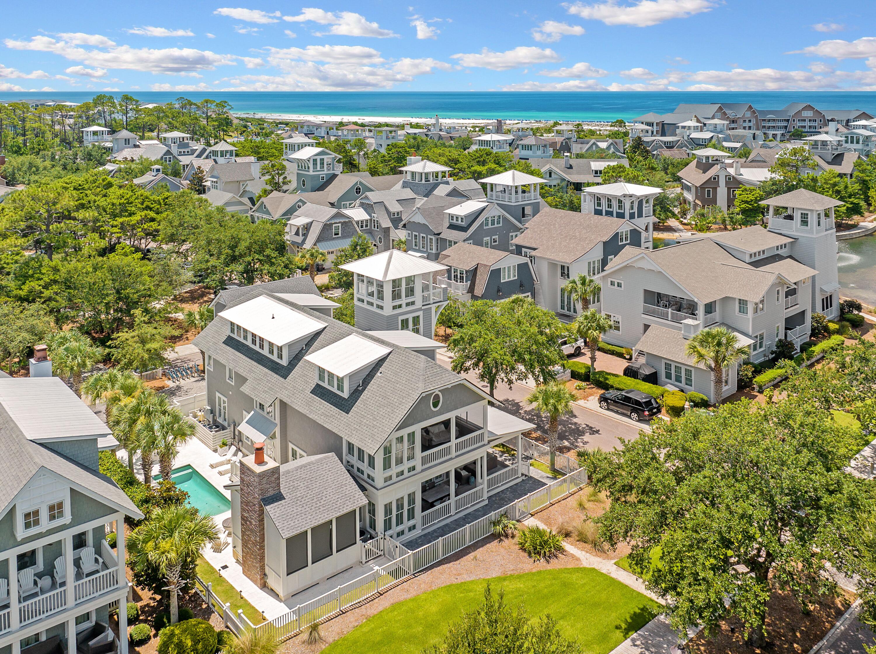 Positioned on a corner lot just south of 30A, this refined WaterSound Beach residence is a masterclass in elevated coastal living. Encompassing more than 5,100 square feet of conditioned space, including the connected pool porch cabana, this six-bedroom, six-and-a-half-bath home, along with a newly built carriage house, offers three distinct entertaining areas, each thoughtfully designed to accommodate gathering or retreat. A screened pool porch cabana with integrated air conditioning opens to a private outdoor sanctuary, complete with a large heated pool, fire pit, and summer kitchen, perfect for relaxed evenings under the stars on one of the larger lots in WaterSound Beach. Inside, natural light pours into the expansive main living area, where reclaimed wood ceilings and tongue-and-groove accent walls showcase the work of Magnolia House Design Group.
The kitchen is a chef's dream, outfitted with Thermador appliances, a gas cooktop, leathered countertops, dual dishwashers, and a spacious center island. Just off the main living space, a serene primary suite features a dedicated sitting room and a luxurious bath with a deep soaking tub, a large walk-in shower, and artisan tile. Upstairs, three additional guest suites offer privacy and comfort, while the third floor hosts a sprawling bunk room with beds for 12, its own media lounge, and a private bath. A carriage house, completed in 2023, adds flexibility for hosting or extended stays. Additional features include reclaimed hardwood floors, tankless water heaters, a whole-home audio system, plantation shutters, designer lighting, and a second-level bed swing. This home enjoys all the privileges of WaterSound Beach, including deeded beach access to over 1 mile of private beach, two community pools, miles of boardwalks and trails, kayak rentals, and close proximity to The Big Chill, Alys Beach, and Rosemary Beach. Whether you're searching for a luxurious primary residence, a second home, or a high-performing rental, this property offers rare versatility in one of 30A's most exclusive gated communities.