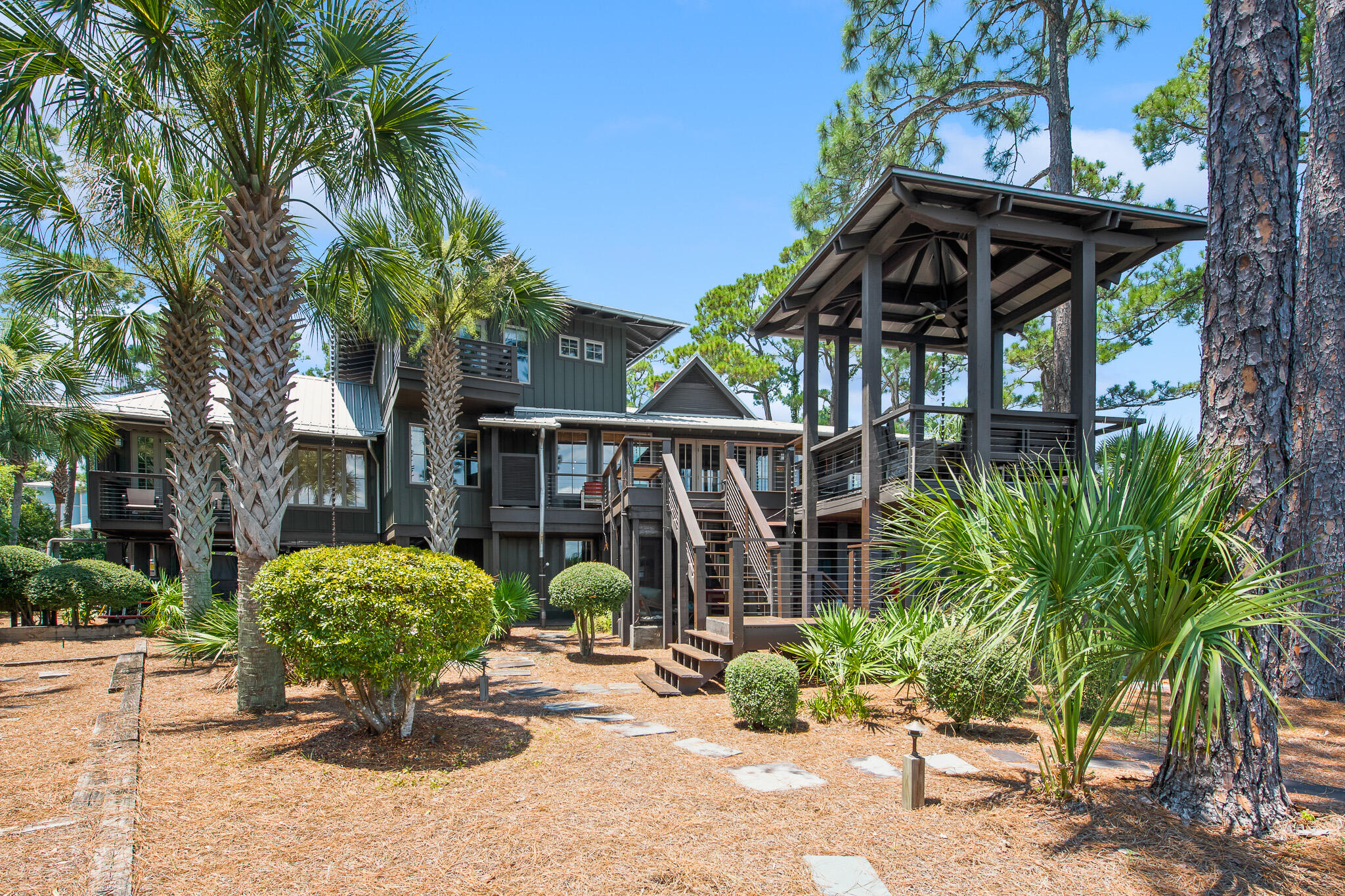 Designed by award winning architect, Carey McWhorter, this custom-built lakefront home is the quintessential coastal dune lake retreat. Set on a half-acre in Grayton Beach and spanning 180 feet on Western Lake, this home has been expertly constructed and thoughtfully designed. Touting rare natural beauty and expansive water frontage, this sanctuary lends breathtaking panoramic views as well as unmatched privacy.  Upon arrival, the lush landscaping sets an immediate element of nature and relaxation. The large veranda porch is complete with outdoor seating. Stepping through the double, full-glass front doors into the main floor of the house, you are greeted with your first views of Western Lake...