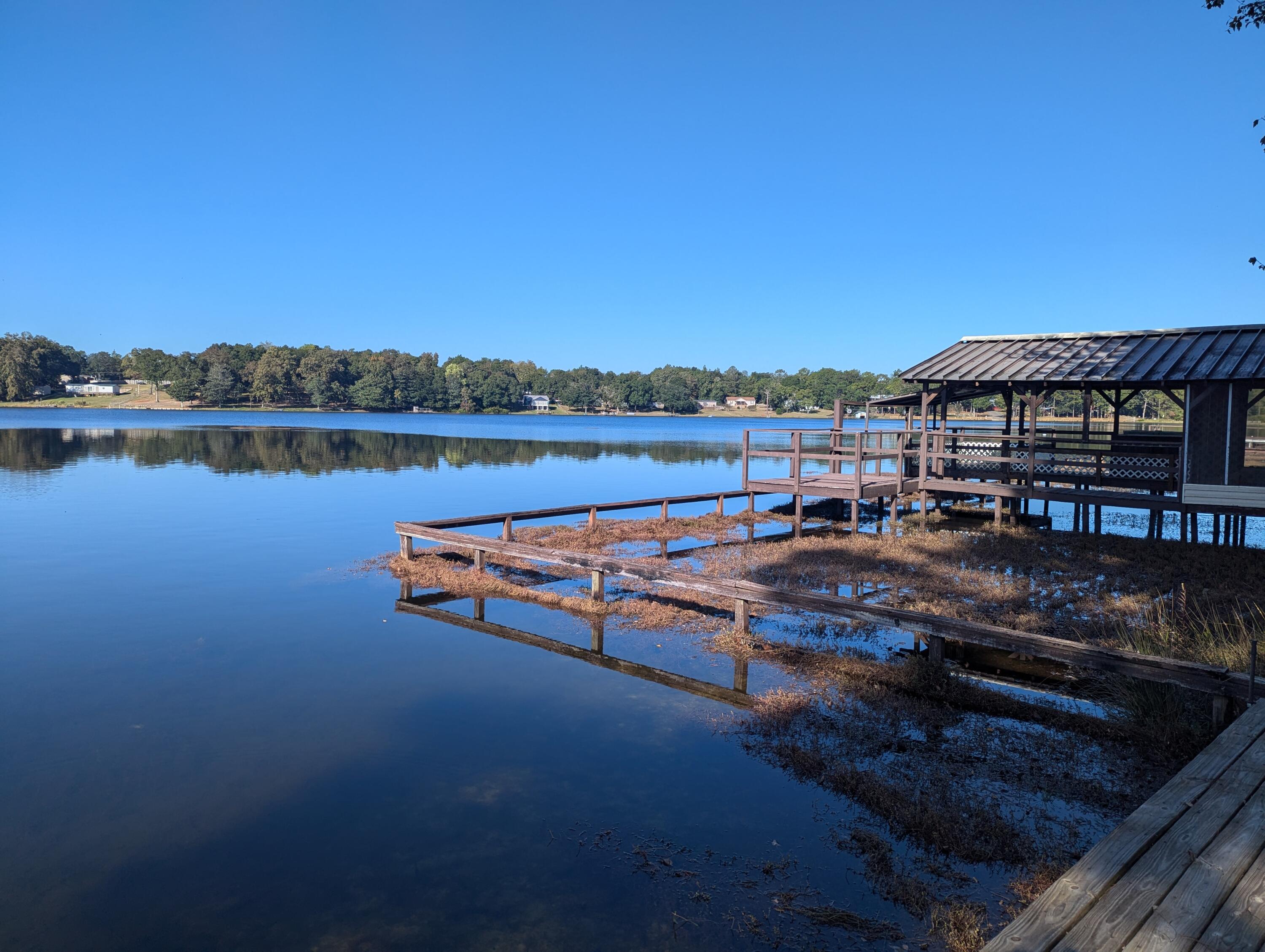 Waterfront property with a two (2) bedroom, two (2) bath home on King Lake.  The street name says it all 'Paradise Island Drive'...vacation home, full time home, AirBnB - the possibilities are unlimited, your imagination controls what this location could provide you.  Fully screened in boat house with a dock for you and your guests to enjoy either early morning coffee or the nightly sunsets - the entertainment is up to you.   Galley kitchen, Florida room, gas fireplace.   One bedroom bath downstairs and one bedroom bath upstairs with a balcony facing the water.   Yard building on the property, one car garage with two driveways - fully fenced and covered front porch.