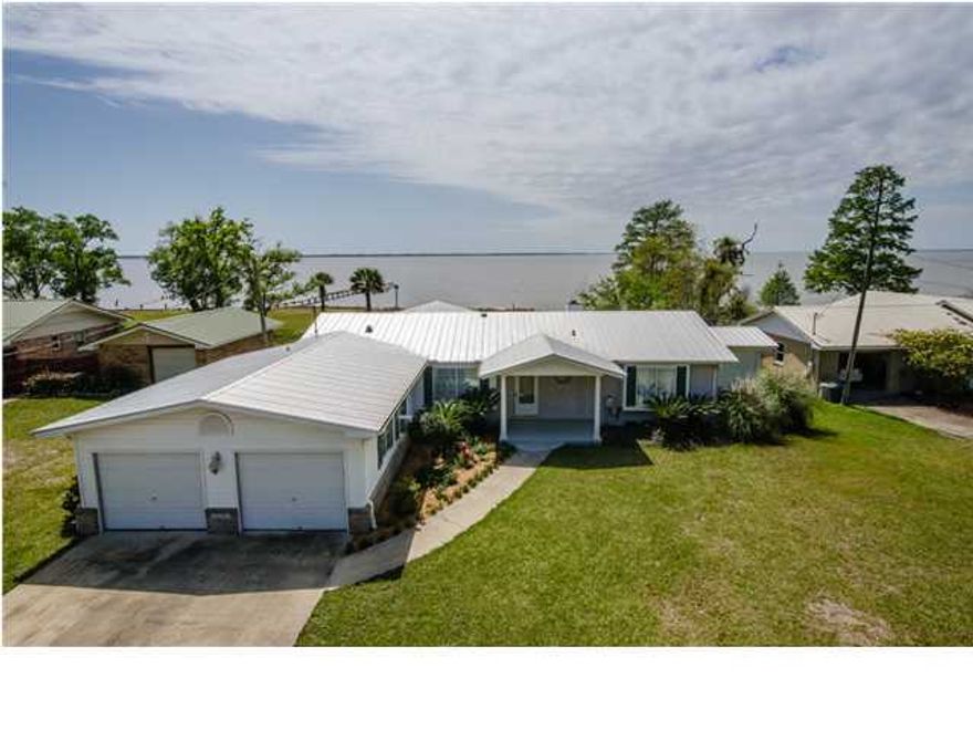 Contract Contingent upon Buyer Home Closing on 4/21/12015. Taking Back Up Offers that will be effective if this fails contract fails to close. Great Bay Front Property! Location, Location, Location! 90 feet on the Bay!! This home was extensively remodeled in 1997 with an addition of 1053 square feet of living space plus a large 2 car garage! HERE ARE A FEW ADDITIONAL DETAILS: Grand Boulevard where you'll find shopping, dining and entertainment! It is also an easy 30 minute drive to the new Northwest Florida Beaches International Airport. Enchanting waterfront views from most every room in the house. Tiled floors in foyer, breakfast area (or office), kitchen and all three baths. Enjoy the large master bedroom with vaulted ceiling; master bathroom has two walk-in closets
