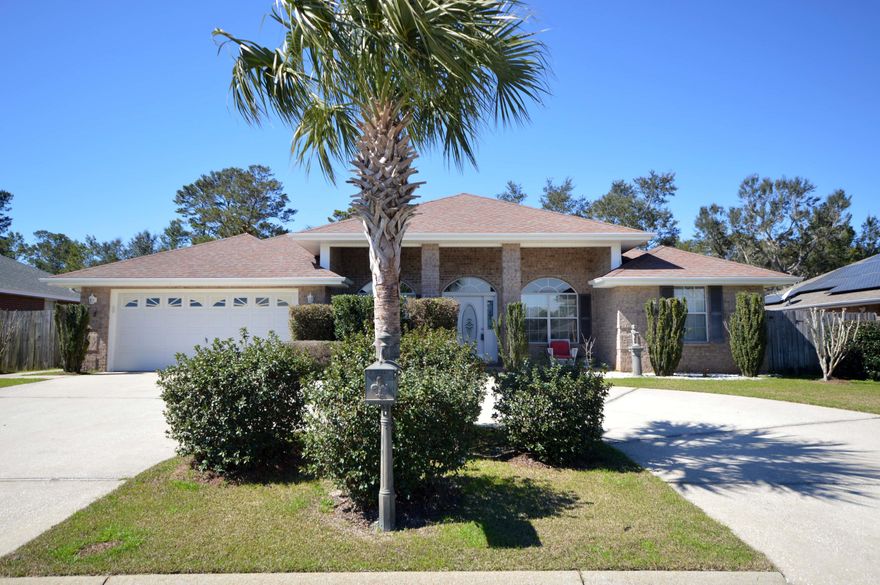 Great curb appeal with circular driveway! Welcome to this 4 BR/2 BA 2200sf home in Navarre. This contemporary split floor plan home features main areas beautiful laminate wood flooring, a large fireplace,  and a breakfast nook off the kitchen. Stainless Steel appliances &  cherry cabs make this kitchen stand out!  Located in the quiet Waterstone neighborhood with low HOA,  this 4/2 home is just a short commute to Hurlburt, the beach, and the larger cities of Pensacola; Inside you will find a formal dining room that is great for family and friend gatherings; The bonus room is perfect as an office, playroom or art room.The Master suite is spacious with garden tub, a separate shower, double vanity and walk in closets. Back yard has privacy fence and you will enjoy relaxing on the back covered