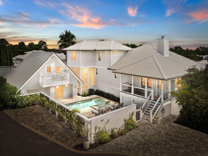 This exceptional seven-bedroom, six-bath residence is thoughtfully designed to accommodate every lifestyle, whether as a full-time family home, a vacation retreat, or a multi-generational gathering place. Situated just moments from the sugar-white sands of the gulf, it offers a private pool, carriage house, and two additional lock-out units, providing unmatched flexibility for owners and guests alike. Inside the main house, light-filled living spaces are framed by minimalist white walls, warm wood accents, and graceful crown molding. Wide-plank flooring leads toward the heart of the home -- a striking kitchen anchored by a vast island and bar with seating for five. Perfect for casual breakfasts or evening cocktails, this social hub is complemented by a textured white tile backsplash, custom cabinetry, and stainless steel appliances, including a double oven set beneath an oversized hood. Nearby, the dining area comfortably seats ten beneath contemporary pendant lighting, while the adjacent sitting room invites relaxed conversation around the fireplace and TV. The primary suite is generously proportioned, offering space for a desk or sitting area, and a spa-inspired bath complete with an oval soaking tub, dual vanities featuring vessel sinks, and a soothing atmosphere designed for indulgence. Upstairs, quiet nooks and private balconies offer serene escapes, complemented by three additional bedrooms and three and a half bathrooms, providing ample space for family and friends. Beyond the main residence, this home's versatility shines. A two-bedroom garage apartment is accessed by a private elevator, ideal for guests or renters seeking privacy. The pool house features a king-size bedroom, bunk beds, and a living area with a full bathroom  perfect for family fun. Above, the carriage house offers an additional bedroom, bathroom, kitchen, and open living space, extending hospitality with ease. The outdoor spaces are equally inviting, featuring a sun-drenched terrace that overlooks the pool, spa, and barbecue area. Ample parking includes driveway and rear spaces equipped with EV charging stations, a climate-controlled two-car garage, and a heated and cooled RV garage  together providing abundant room for vehicles, bikes, and beach gear. An interior elevator conveniently links the main garage and guest apartment with the main home. With no HOA restrictions, this remarkable Blue Mountain Beach property offers rare flexibility, serving as a permanent residence, vacation retreat, income-producing rental, or a seamless combination of all three.