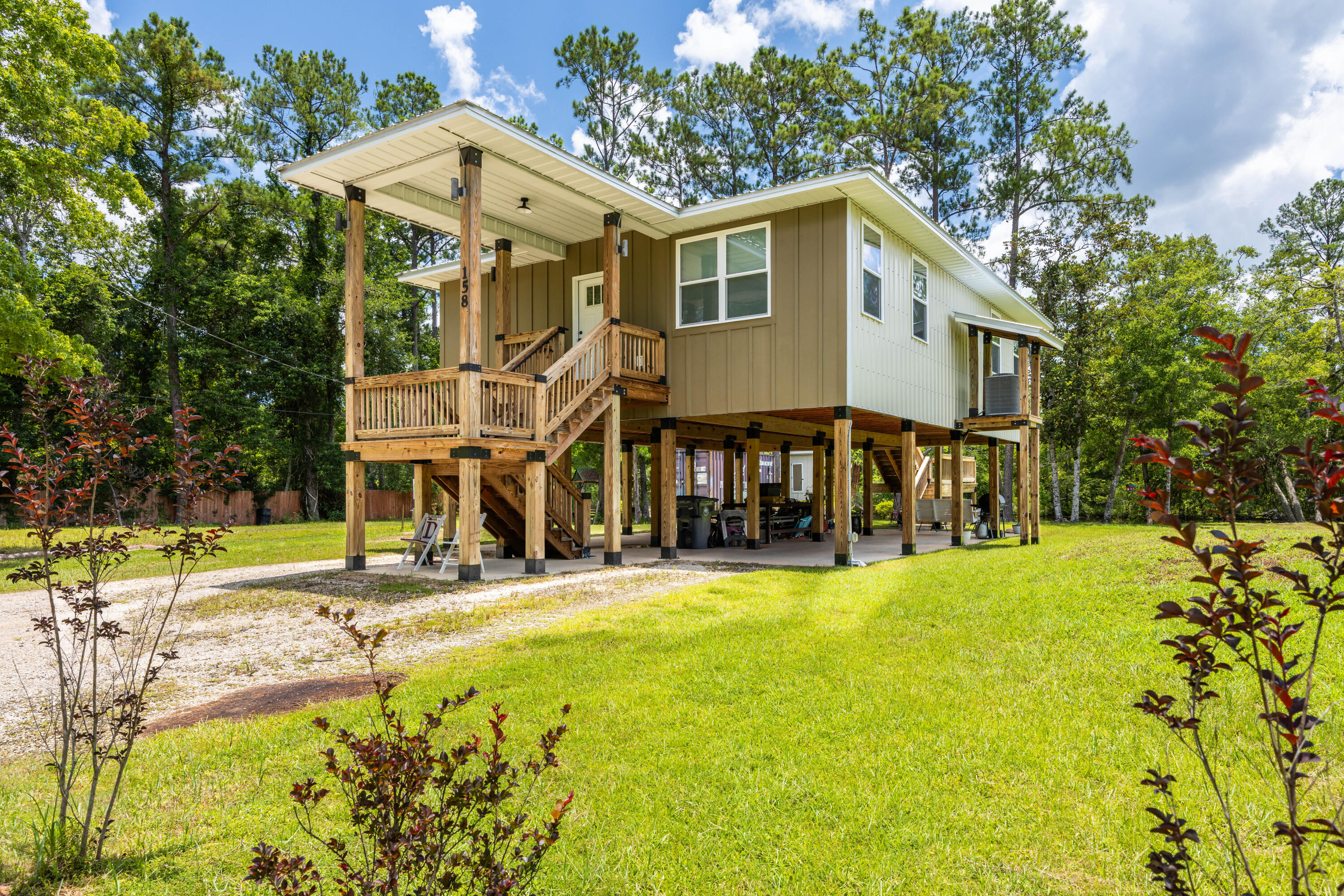 Owner Builder, Custom Built - Waterfront Florida Cottage on Alaqua Creek.This MUST SEE one-of-a-kind, custom waterfront home--designed by Designs by Vision--showcases exceptional craftsmanship and innovation. It features the patented Ty-Rite System, a revolutionary piling installation method where no wood touches the ground, ensuring superior durability and longevity. This system makes this home stronger than any other wood-pile waterfront home in the area! The home is elevated on wood pilings with a solid concrete foundation, enhancing flood protection, promoting air circulation beneath the structure, and significantly reducing long-term maintenance costs. The elevation also provides ample space to store a 20' boat and park up to four vehicles. Enjoy stunning views of Alaqua Creek from the spacious 10' x 20' covered porch, complete with custom steel-capped handrails. Inside, the open-concept living and kitchen area with an island offers incredible waterfront views. and is outfitted with custom solid wood cabinetry built from ?? inch poplar wood, finished with crown molding. The kitchen features 1.5" thick granite countertops, a large island, 9' ceilings with crown molding, waterproof vinyl wood flooring throughout, LED lighting, and Whirlpool appliances. The home is equipped with a 2 Ton Carrier HVAC system with heat pump (14 SEER) for year-round comfort.
Bathrooms include custom solid wood vanities, granite countertops, and ceramic tile flooring. Exterior features include Hardy board front siding, 29-gauge steel metal roofing and siding, a mound septic system, and a 4" well with two advanced filtration systems to ensure clean, safe water. The home is also pre-plumbed for an outdoor shower, perfect for rinsing off after fishing or watersports days or gardening. Recently pressure washed, the home is designed for low maintenance and watertight performance.
Affordable home on deep water that goes out to the Bay! Located near the Alaqua Creek Park Public Boat Launch, this property offers direct and quick access to Choctawhatchee Bay. No comparable homes in the area for this price. Homeowners and Flood insurance is very affordable, and utility bills remain low!
Best of all, there are no HOA fees or restrictions