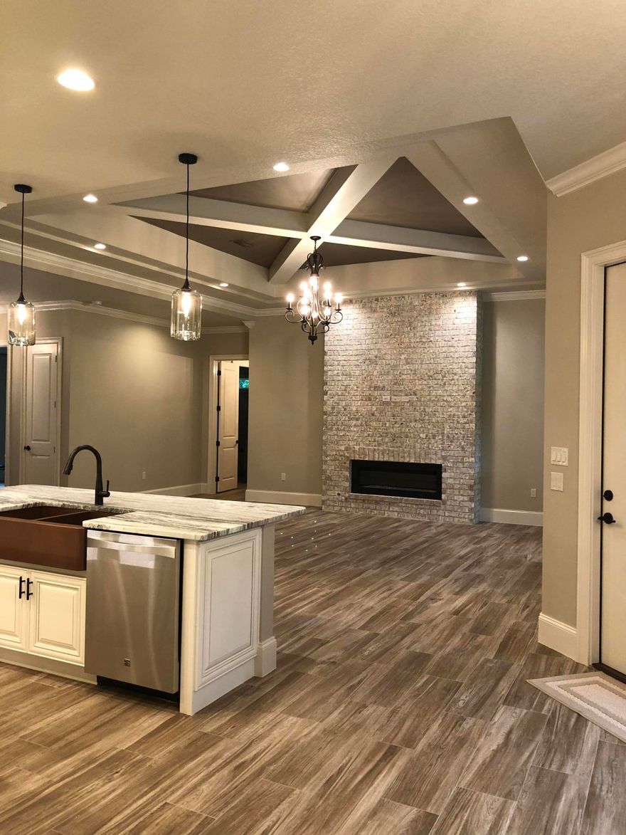 2018 Parade of Homes entry by award winning builder! Quality construction in a gated community and curb appeal galore! This 5 bedroom 3 full bath home with 3 car garage features an amazing open floor plan with tall ceilings, lots of huge windows, 8 ft tall doors, Tankless Rinnai Gas water heater, spray foam insulation, high efficiency AC, Linear gas fireplace with floor to ceiling brick surround, 8''x 36'' wood plank ceramic tile, specialty granite counter tops throughout and intricate ceiling details throughout. The kitchen feature a 36'' gas cook top, wall oven and wall microwave, copper double bowl apron front farm sink, center island,glazed cabinetry, and pantry. Tongue and Groove ceiling on the covered porch, and too many details to list. Close to everything and built to impress!