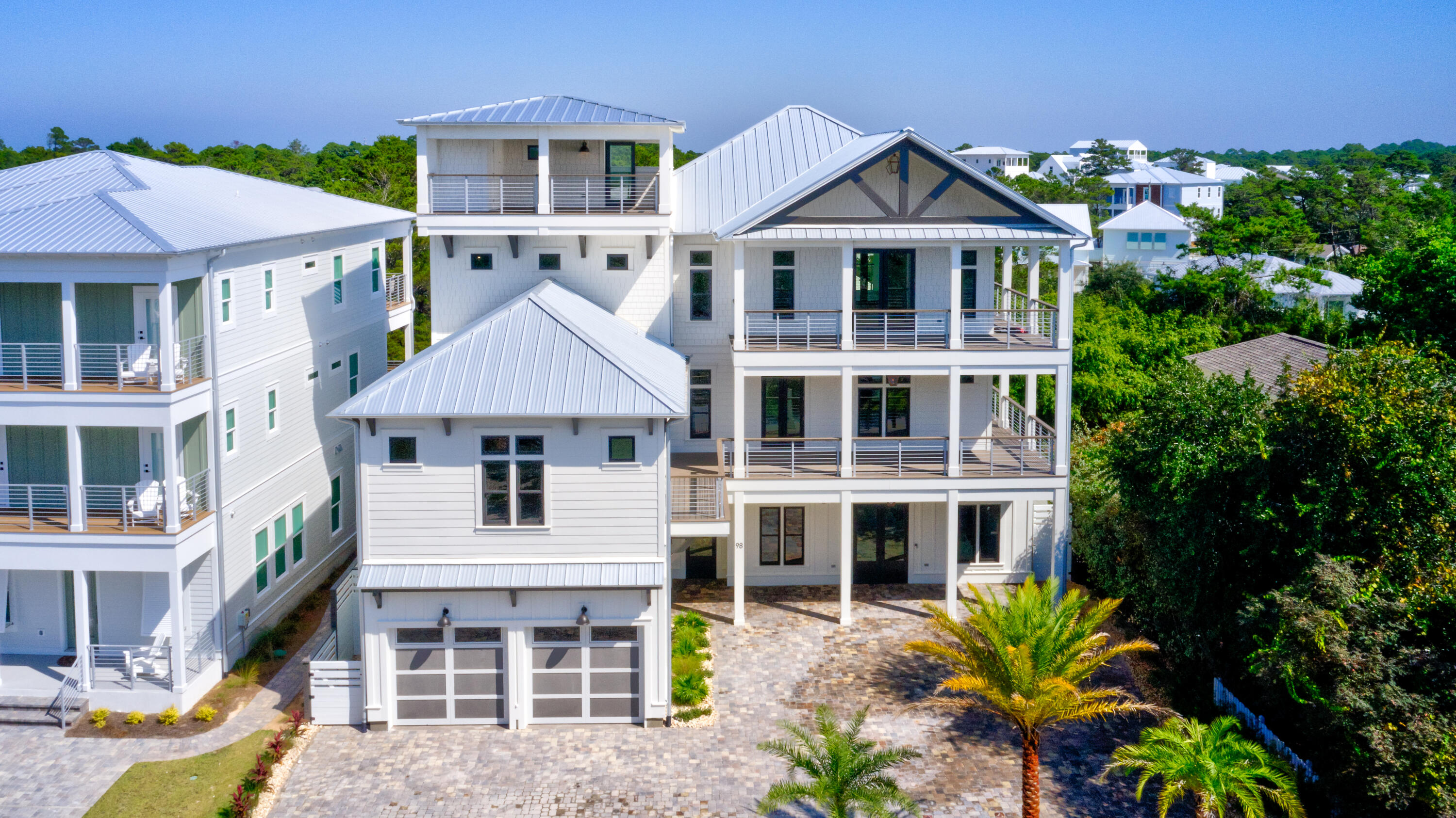 The Beach Escape truly holds up to its name. This exquisite property exceeds all expectations, whether full time, second home, or vacation property. This home has all the amenities of a coastal vacation and within a few minutes to three beach accesses. This four story Coastal Beach House hosts beautiful porches and walkover to carriage house. The fourth floor lets you gaze at breathtaking gulf views and amazing sunsets. This property offers spacious room for living or vacation rental with seven bedrooms including full bunk room, gourmet kitchen, gas range, wet bar, wine cooler, and pot filler. Perfect for entertaining. The dining and living area with its Euro doors opens up to a large covered lanai. Enter into a resort style pool with hot tub , waterfall, and fire pods. Outdoor kitchen