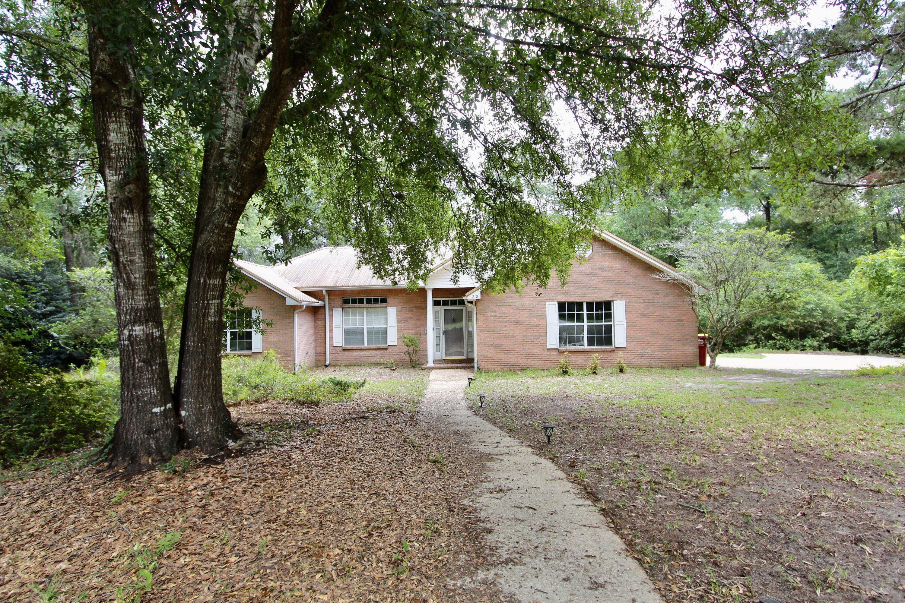 Beautiful 3-bedroom, 2-bath home situated on a spacious 0.48-acre lot with stunning views of a par-9 golf course. This well-maintained property offers two separate living areas and a formal dining room, providing ample space for both everyday living and entertaining. The upgraded kitchen features granite countertops, a stylish tile backsplash, and elegant tray ceilings, creating a perfect blend of function and style. The master suite is generously sized and includes tray ceilings, a large walk-in closet, and plenty of room to create your personal retreat. Enjoy peaceful evenings or host guests in the screened-in back porch overlooking the beautifully maintained backyard and golf course beyond. Additional highlights include a durable metal roof 2013 & HVAC and hot water heater installed in 2021. With its desirable layout, thoughtful upgrades, and prime golf course location, this home is a must-see.