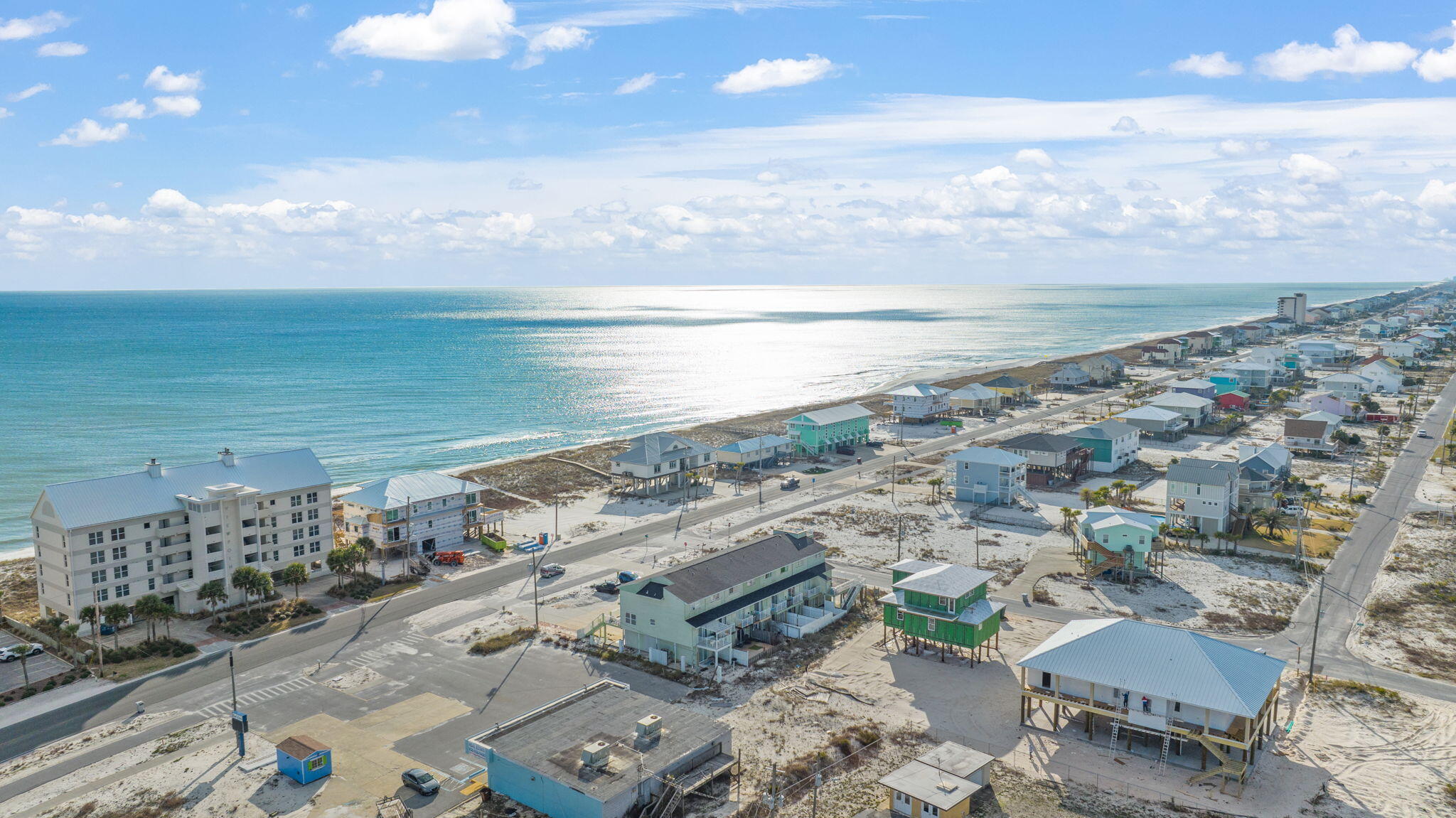Welcome to the most affordable views on the Emerald Coast of Navarre Beach! This charming coastal townhome provides water views, a short walk to the beach, and it's fully furnished! There's a bonus lock out room down below that has a full bath, mini kitchen, and studio bedroom (4th room but not added on MLS) with a small fenced yard. Photos of the studio are last in the photos. The upstairs has a separate locked access to get to the 2nd and 3rd floor. There's three full bedrooms, balconies, full kitchen, and a huge living room overlooking the water. Private balcony with composite decking and durable beach furniture. The very top third floor, provides two large bedrooms, and one of them has double bunk beds. Each bedroom window has water views and plenty of natural lighting coming in.