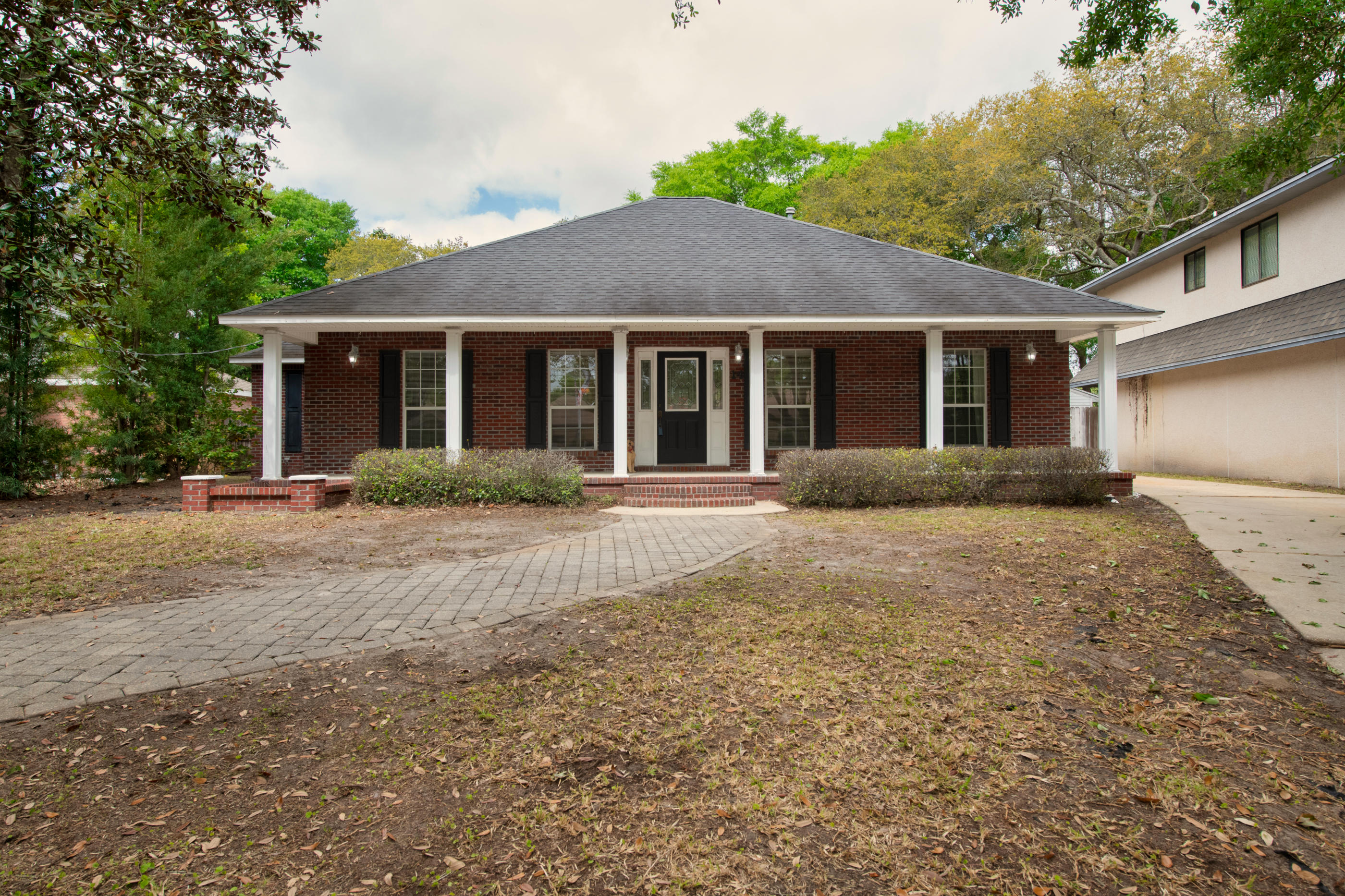 Back on Market! NEW ROOF Prior to closing! 3 bedroom, 2 bath, 2 car garage custom designed home located in central Shalimar on large private lot. This home offers all the unique features of a custom home with such an exciting exterior space. Exterior features include covered front porch spanning the front elevation of the house. The driveway extends from the front of the house to the garage located in the rear of the lot. Plenty of room for RV, boat or extra automobiles. Interior features include large living room with fire place, trey ceiling & laminate flooring. The kitchen offers plenty of cabinets, kitchen island and dining area with bay window.