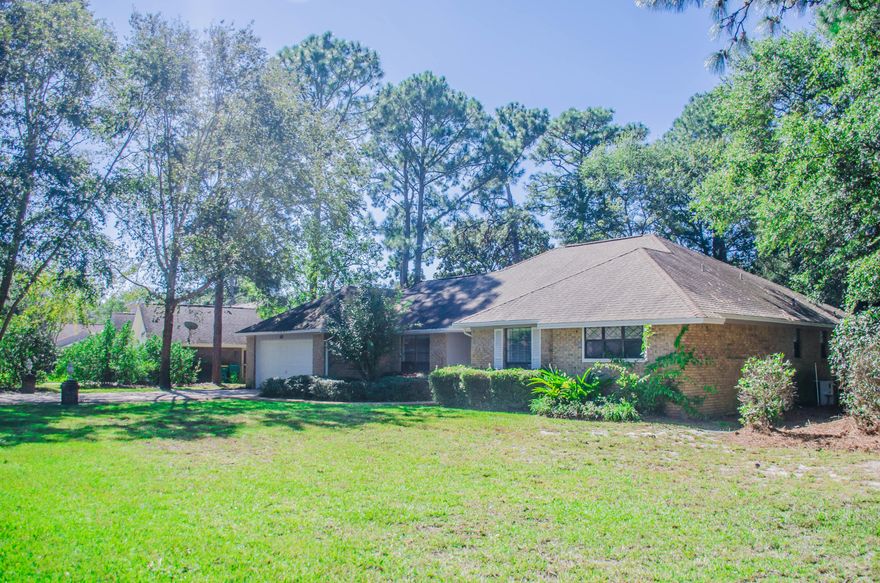 Beautifully maintained home located on a .44 acre corner lot. Family room boast a high vaulted ceiling with a cozy brick fireplace and built in book case. Tile flooring flows throughout the home. New STAINLESS STEEL stove and dishwasher. Open concept floor plan opens up to family room while the breakfast nook leads out to the screened in porch with upgraded screen .The perfect area for that morning coffee while overlooking the beautiful manicured lawn with flowering bushes and fruit trees. Home is extremely efficient with electric bill not running over $173 in the summer. Newer HVAC SYSTEM.Termite bond in place for peace of mind. Formal dining room off of foyer. Floor plan has a spacious master bedroom with 2 walk in closets. Two additional bedrooms share a hall bathroom. Garage is