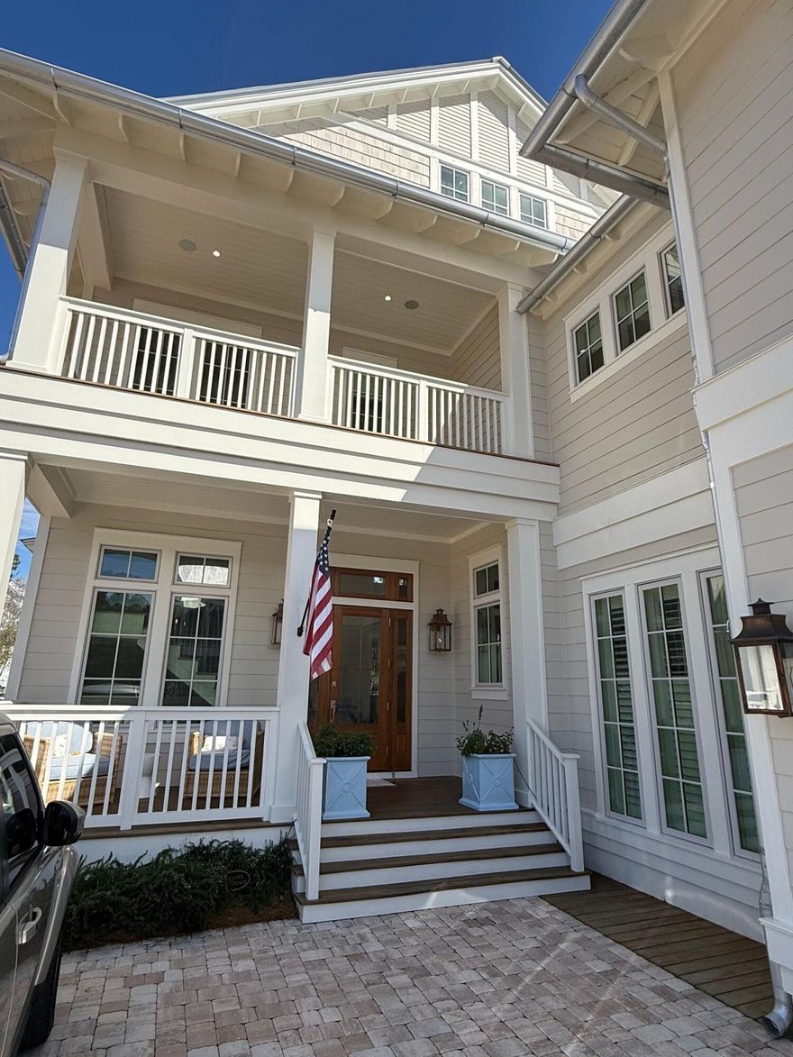 Situated within WaterColor's newest--and quickly most coveted--setting, this gracefully designed residence captures the very essence of refined coastal living.There is a quiet confidence to this WaterColor home, the kind that comes from vision carried through without compromise. Never before offered, it arrives fully realized -- an extraordinary collaboration between architect Greg Jazayeri, builder Borges Brooks, and the discerning eye of Kaitlyn Tiller of Kalon Home. The result is a residence that feels at once elevated and deeply livable, where every detail has been considered and nothing left to chance.Inside, volume and light set the tone. Soaring cathedral ceilings with exposed beams rise more than 20 feet above the main living spaces, creating an airy sense of scale, while .... 
... warm hardwoods ground the home in comfort. The open living, dining, and kitchen areas unfold with ease, designed as much for quiet mornings as they are for lively evenings. A Sub-Zero refrigerator and Wolf range anchor the kitchen, complemented by custom Smithart cabinetry and a discreet butler's pantry that brings both function and refinement to entertaining.

The living room flows seamlessly to a screened porch where a second fireplace and outdoor grill extend the experience outdoors, offering a natural gathering place in every season. Nearby, a custom bar invites conversation, while curated furnishings, designer fabrics, and custom drapery throughout the home lend a sense of cohesion and polish that is immediately felt but never overstated.

Each bedroom is appointed as a private suite, offering both comfort and privacy, with oversized closets thoughtfully designed for flexibility -- even a crib when needed. Upstairs, the home takes on a more relaxed rhythm, with two inviting porches and a generous family game room that creates space for connection, retreat, and play. A bunk room with a king bed below adds both charm and versatility for guests of all ages.

Moments of artistry are woven throughout. A Pierre Frey wall covering elevates the powder bath into something memorable, while Schumacher fabrics, Serena and Lily accents, and custom stairwell art contribute to a layered and collected aesthetic. Even the unseen details speak to the home's level of care, including a whole-house water purification system with demineralization at the kitchen faucetl an uncommon feature that reflects a commitment to wellness as much as design.

Set within one of the area's most sought-after settings, the home offers access to an exceptional collection of amenities, including multiple resort-style pools, miles of walking and biking trails, tennis and pickleball courts, a new fitness center underway, and a vibrant mix of shops, dining, and outdoor recreation.

This is a home that doesn't rely on a single moment to impress. Instead, it reveals itself gradually, through craftsmanship, materiality, and an unmistakable sense of intention--an enduring expression of coastal living at its most refined.