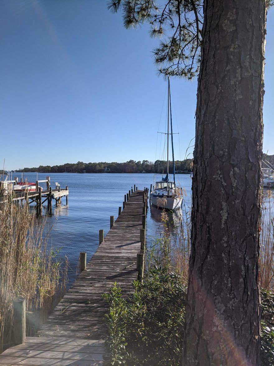 Sailors delight, no bridges to the gulf! Sailboat ready, Rare indeed, deep waterfront town home which has been updated and ready to move in! This home was the original show home when Water Oaks was developed. This is the only property that has it's own pool and extra lawn space with a fence for pets and kids. It checks most all the boxes:1) Waterfront, , 2) Remodeled, 3) Extra space for office or a 4th bedroom, on the main level, 4) Boat slip, and more! great end location convenient to storage and marina if needed. New master bathroom is beautiful.