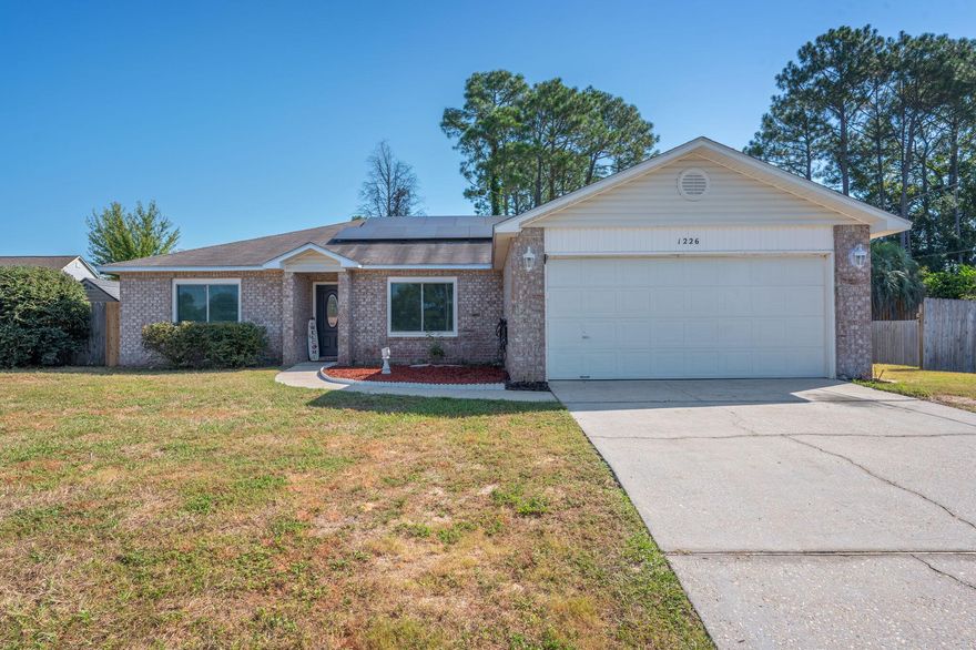 Welcome to this inviting 1,666 square foot home situated on a quarter acre lot. Step in to find four bedrooms with recently installed carpet and two full bathrooms. The spacious primary bedroom includes an en suite with a double vanity and a large walk-in closet. The main living area features high ceilings & durable vinyl plank flooring throughout, creating a cohesive look and easy maintenance. Significant updates have been completed, including replacement of all but one window and both exterior doors in 2023. A NEW ROOF is being installed by the seller. The 2019 solar panels help keep electric costs as low as approximately $30 per month. Additional highlights include a double car garage and a large open back deck, perfect for enjoying outdoor living.