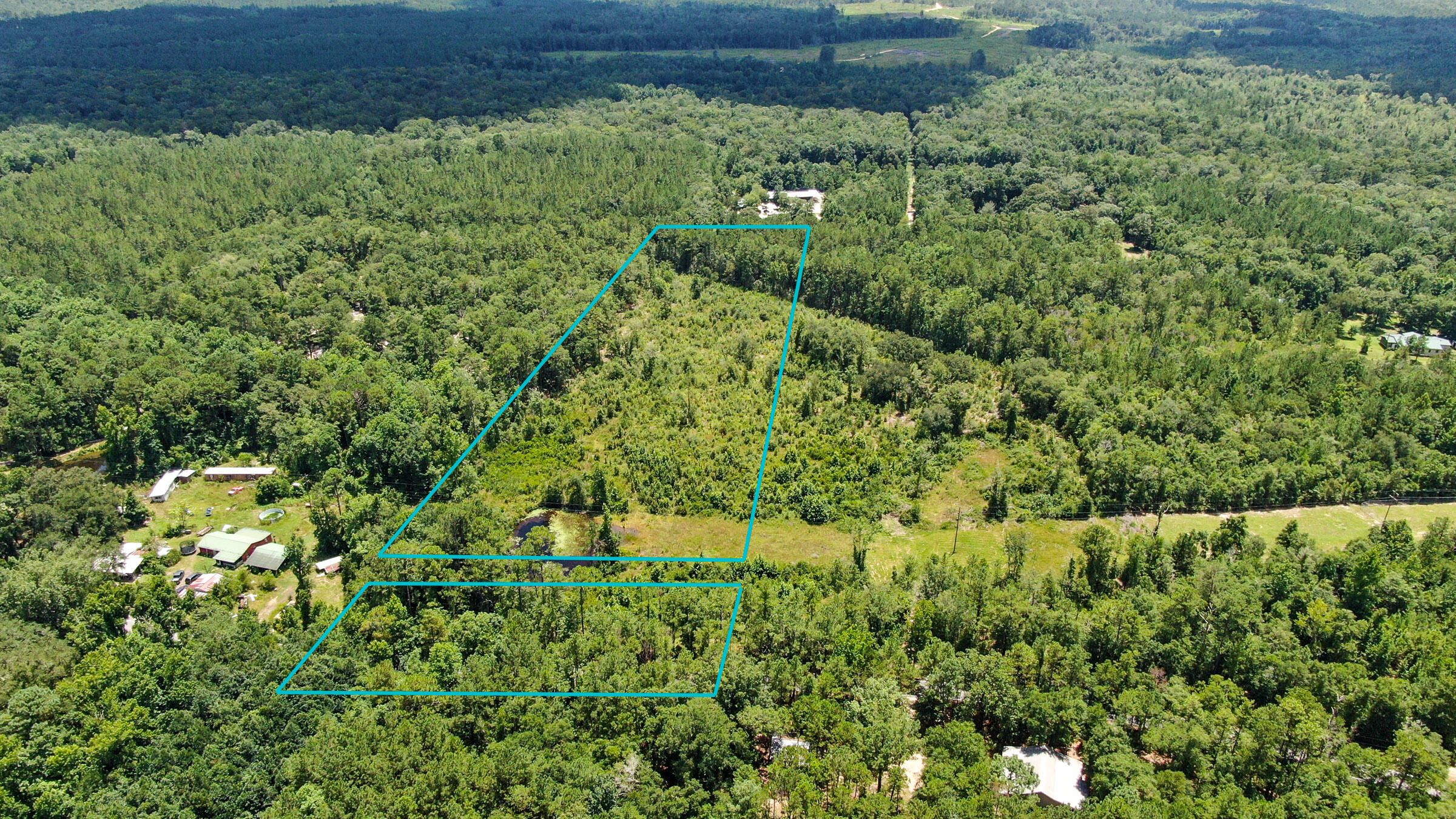 Mostly cleared and level property in the highly desired Eucheeanna Valley. A few large trees and a small pond. Other homesites adjacent and across the road, so access to electric should be easy. Road splits the property. Build or put a manufactured home on it as it is restricted to county regulations only. Seller is firm on the price of this ideal sized property.