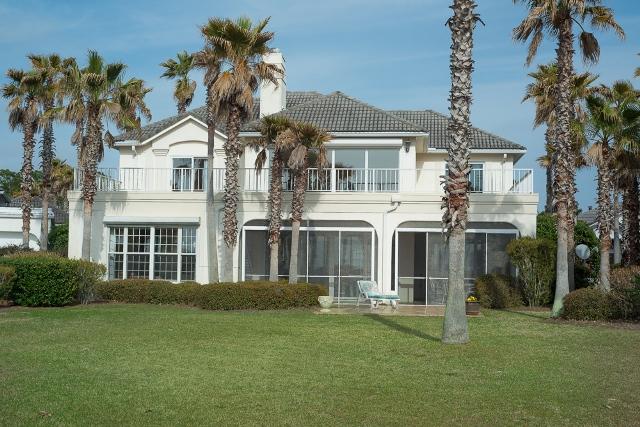 Breathtaking Views!!! Awesome Sunsets!!! Beautiful Custom Built home. Upon entering foyer into open Dining and Family Room with breathtaking views to the well equipped kitchen featuring new radiant top stove, microwave and newly created chopping block opening to casual dining and leisurely entertaining. Step out onto screened wrap around porch. Master Bedroom with spacious Master Bath with views of Bay also opening to screened porch. 2nd Story offers 3 Bedrooms, balcony, landing and 2 bathrooms. Stunning views throughout. Electric Hurricane shutters, over-sized garage with storage for golf cart. Enjoy peace and serenity in a quiet private area with Security of gated community with a clubhouse and pool. Enjoy spectacular views and sunsets.