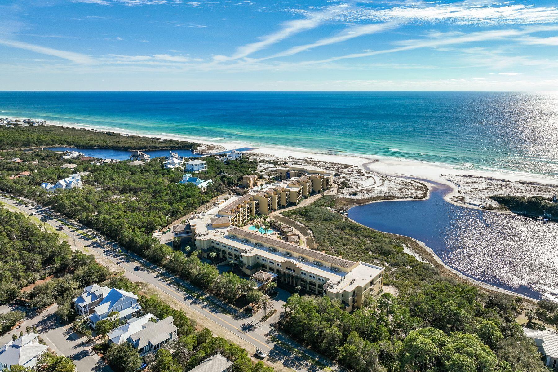 A luxurious beachfront retreat, this elegant condo offers custom finishes, pristine amenities, and breathtaking views of the Gulf of Mexico and Big Redfish Coastal Dune Lake. This top-floor condo provides 3,169 square feet of living space with an open floor plan and four spacious suites. Thoughtfully designed, interior finishes include travertine flooring and high-end furnishings throughout. The first level offers two spacious guest room with ensuite bathrooms. Perfect for those who love to cook, a spacious chef's kitchen features ample cabinetry, a large center island, granite countertops, and Viking appliances. Enjoy casual meals from the breakfast bar while a large dining area is ideal for gathering with family and friends. A large wet bar featuring a beverage cooler adds convenience.