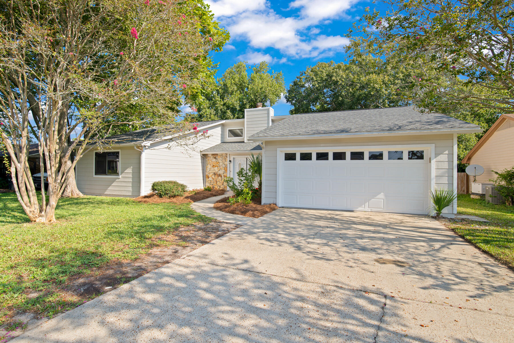 Priced to Sell below market value! Fully renovated 3BR/2BA in the heart of Destin- with new roof, 2 HVAC units, and stainless steel appliances. Spanning 2,423 sq ft, this open floor plan features cathedral ceilings, a stone fireplace, formal dining, and large windows that fill every room with natural light. The updated kitchen offers a pass-through bar and oversized island, while the darling heated & cooled Florida room expands year-round living. Primary suite boasts 3 walk-in closets for exceptional storage. Outside, the wonderful yard is perfect for kids. With a 2-car garage and prime location close to Harbor Blvd, shopping, dining, and Destin beaches this move-in ready coastal retreat is a rare find! Schedule your showing today!
