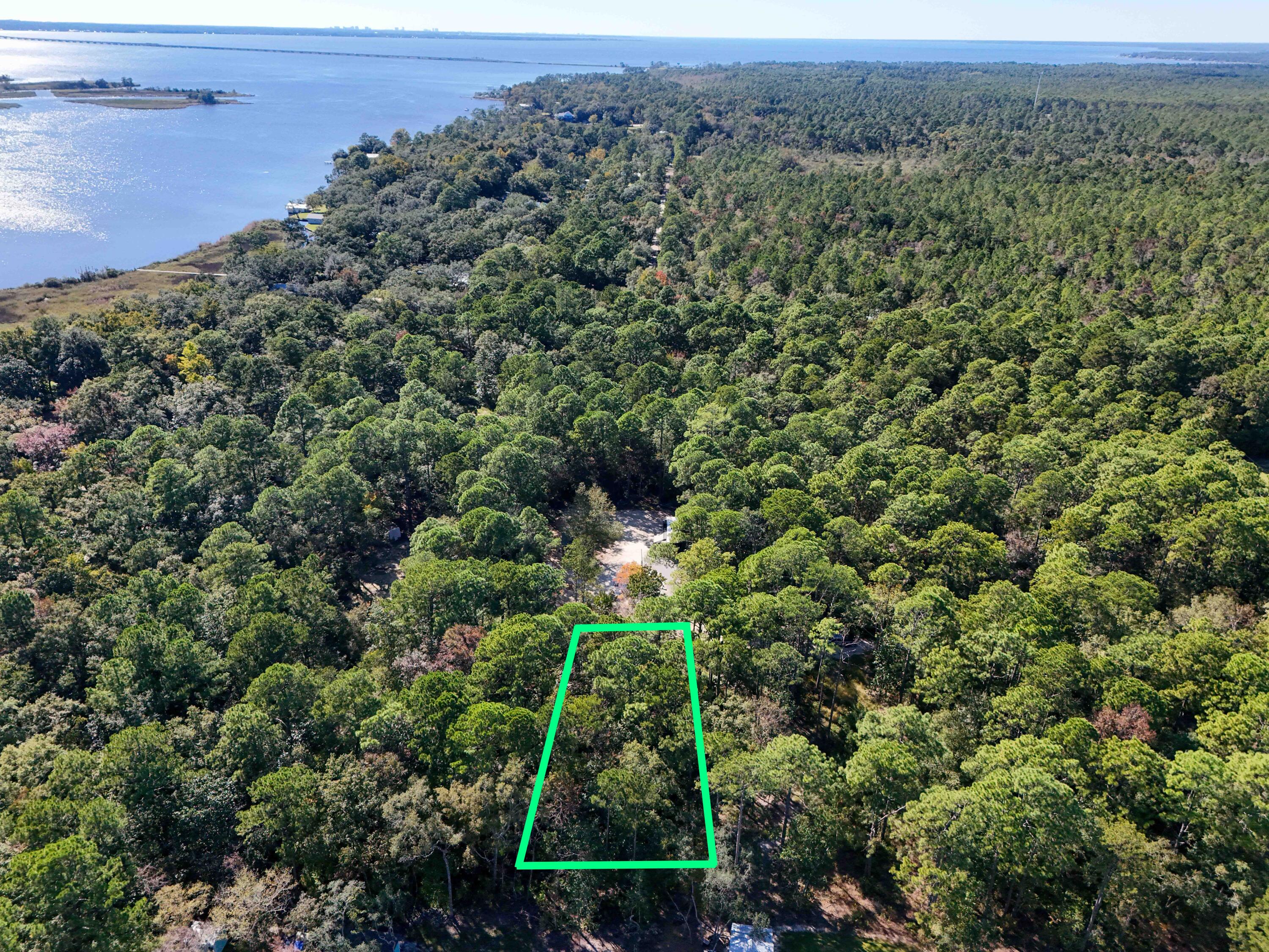 Beautiful wooded lot with pretty live oak trees in South Freeport, close proximity to the Choctawhatchee Bay and 331 Bridge. This 0.18 acre lot is located in Flood Zone X. Electric is available on the street. Zoning does allow for mobile homes. Pitts Bayshore Public Park at the end of the street is available to use for kayak/canoe or small boat launching. Other nearby local spots include: Live Oak Landing, Black Creek General Store, Black Creek Cafe, Ol' Timers Country Store and Grady Brown Park. The beaches of 30a are just a short drive away. Come find your peace and quiet.