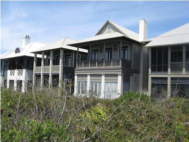 GULF FRONT HOME with Carriage house designed by Architect Tom Christ and built by Mark Breaux Construction.The main house and has 2 bedrooms, a loft, and 3 baths. Tastefully decorated throughout this home features hardwood floors, tumbled stone in the bathrooms, stone fireplace and built-ins in the open living room, vaulted wood ceilings, ceiling fans, subzero refrigerator, and a loft for an additional sleeping space, spa tub in the master bath with separate shower. Both the sleeping patio off the Master Bedroom and the balcony adjacent to the living area have fantastic gulf views. The Carriage House offers an additional 441 sf of living area with one bedroom loft and one bath, french doors to the balcony, hardwood floors, wood vaulted ceiling, plantation shutters and recessed