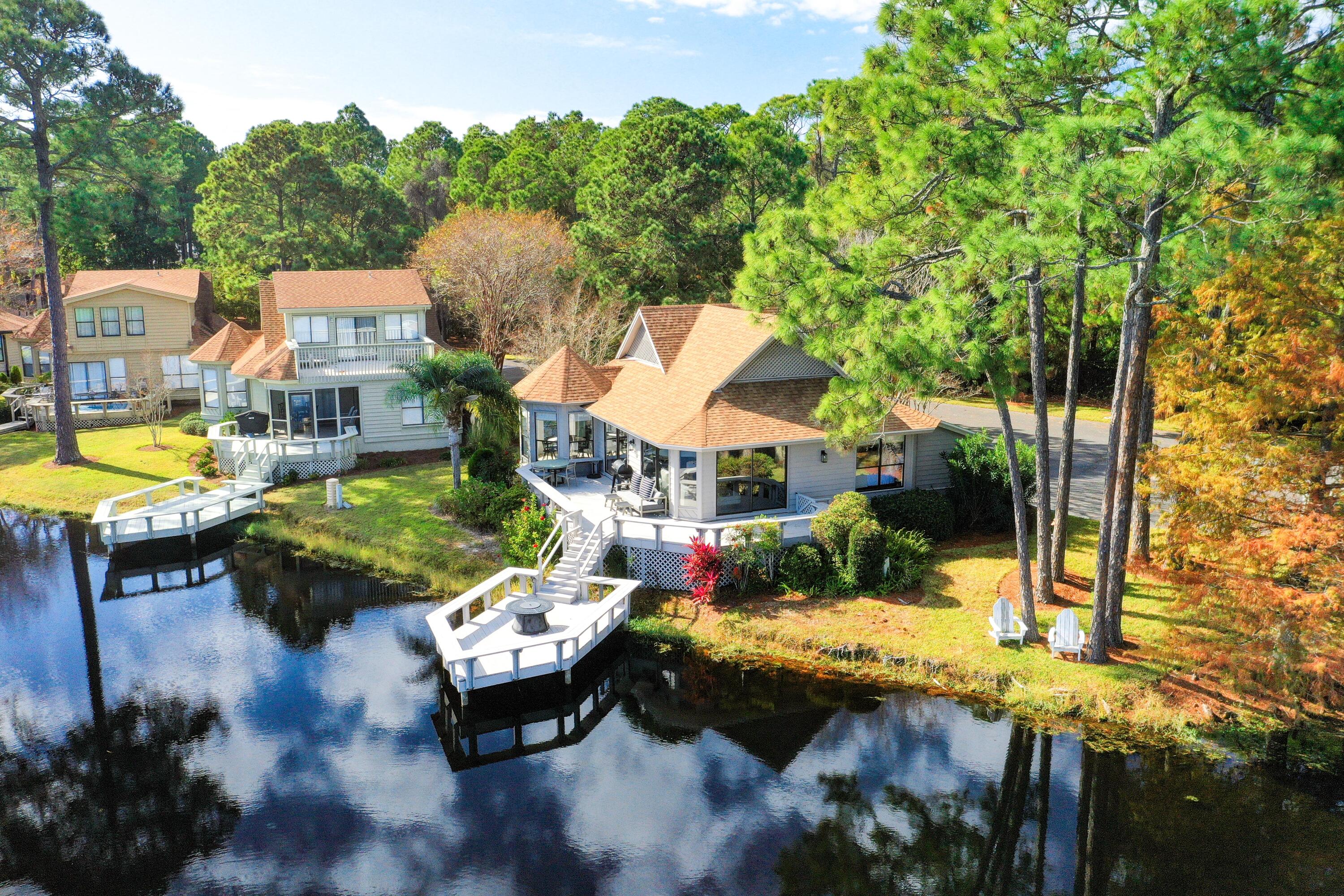 While lounging on the deck extended over the lake, take in the expansive views of the Links Golf Course & Choctawhatchee Bay. The open wrap around patio provides ample space for outdoor seating or yard games. The interior of the property is fully updated with luxury vinyl plank flooring, shiplap walls, and so much more. The numerous sliding glass doors and windows provide an abundance of natural lighting throughout the living space and dining area. The living room seamlessly connects to the Florida Room with a separate seating area. The split floor plan allows for plenty of privacy between the primary suite and guest bedroom. The Primary suite provides a king sized bed allowing for optimal comfort and a private bathroom next to the spacious walk in closet.