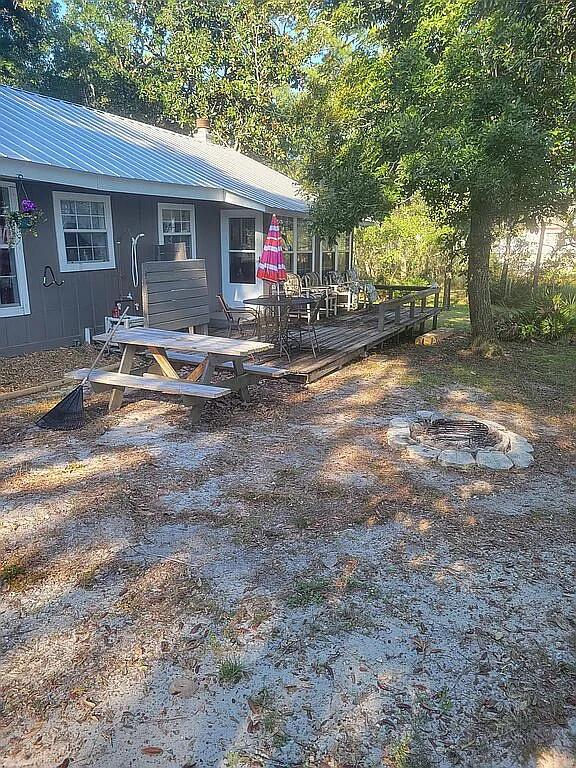 Cute bay front 'Fishing Cabin' located on 3 lots, recently converted to one, via survey. Wood burning fireplace with insert to convert to electric heater.9 ft above waterline, comes with all appliances, fully furnished, just bring your clothes and fishing gear. Includes two wall air conditioner units and 9000 btu portable air conditioner Cabin is sold As Is. Dock is rebuilt and ready for the fishing enthusiasts, has sea wall and, bulkhead. Property is a labor of love in progress, but ready to move in. Property includes 8ft storage shed and 12x24 Garage/cabin that is portable. Truly a waterfront oasis. Would be an absolutely fabulous 'fish camp' to enjoy yourself or to rent out. Enjoy an evening on the deck with a fire in the pit, watching the occasional dolphin swim by.