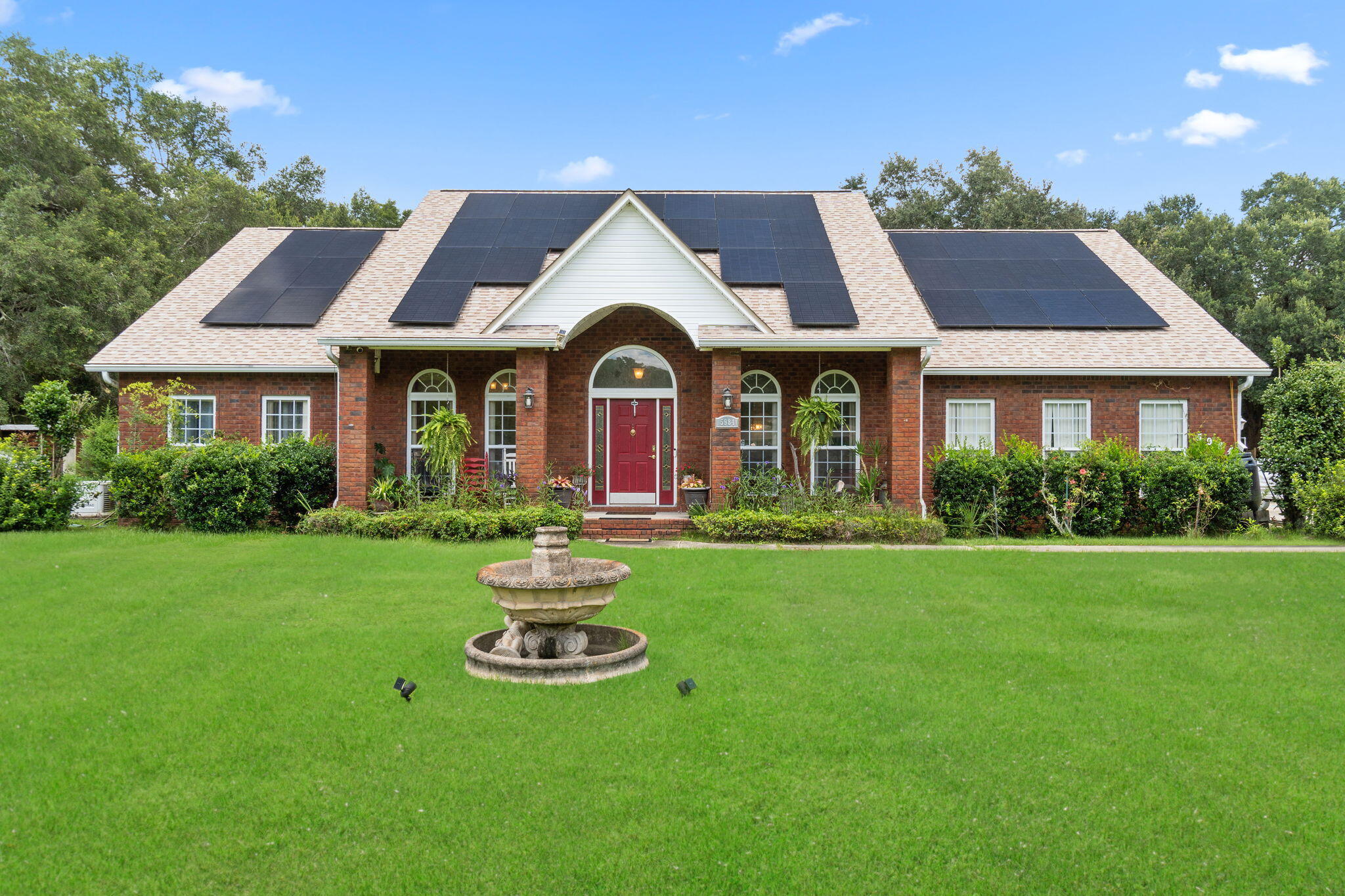 Beautifully updated 4BR/3BA home on nearly 9 acres with in-ground pool (new liner) and private pond via short trail. Recent upgrades include fresh paint, new appliances, paid-off solar panels at closing, and whole-house water filtration. Kitchen offers stainless steel appliances, breakfast bar, nook, and formal dining. Split floor plan with master suite featuring pool access, garden tub, and separate shower. Acreage supports small livestock--chickens, ducks, and peacocks currently on property. Extras: 24x12 workshop with power, 2-car side-entry garage, large parking pad, and whole-house generator. Minutes to shopping, dining, and hospital.