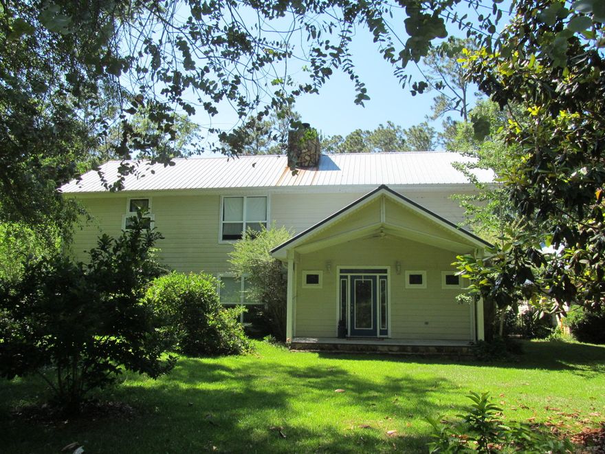 PRIVACY PLUS included with this Custom built 3394 S.F. home with a salt water in ground pool and 23 wooded acres. Located south of I-10. Easy access to the beaches of South Walton. The home includes 3 bedrooms, 3 baths & a huge open living room with a 30 ft. floor to ceiling Carolina Blue Stone Fireplace. Tongue & groove wood floors throughout with tile floors in the in kitchen, utility room & Florida room. The property offers an abundance of fruit trees including peach trees, an apple tree, a nectarine tree, satsuma orange trees, blueberry bushes, a Japanese persimmon tree, fig trees, pecan trees and more. Trails through out the property, a pole barn, chicken coop and goat pen make this country hideaway user friendly and ready for you to enjoy true southern country living.