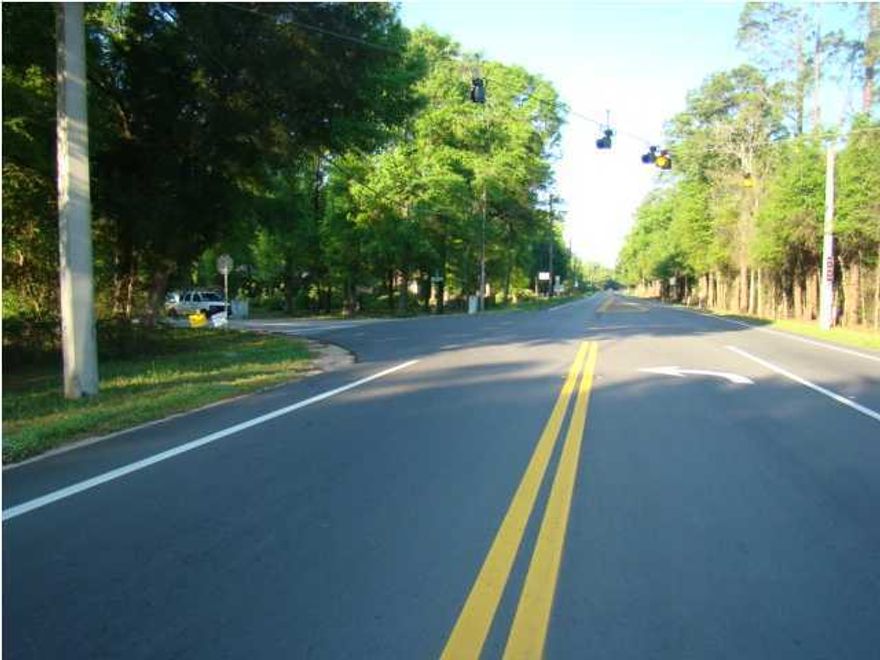 Great Commercial Site! Property is surrounded by 4 paved streets, Hwy 90 W , Hwy 189 (connecting to I-10), Southside and Johnson Street. Great for service station, restaurant, gift shop, antique store...One brick home plus house that was built in 1910. all storage sheds will be removed. Alley way between lots has only been used by owner of the property.