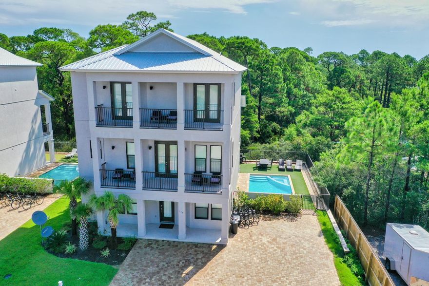 Gorgeous coastal beach home located on the West end of 30A just a short stroll to 30A's newest beach access.  Luxurious interior finishes and professionally furnished by Coastline Interiors, this turn-key property, built in 2017, features six bedroom suites, elevator, wood flooring throughout, and multiple porches overlooking the lush natural landscape adjoining the back of the property.  Features include an over-sized lot with ample parking, private gated yard with large pool, and wrap around putting green.  Perfect for a second home and has exceptional rental potential.  This beautiful property is being offered fully furnished and rental ready, boasting a spacious and open living/kitchen/dining area that is perfect for entertaining family and friends.