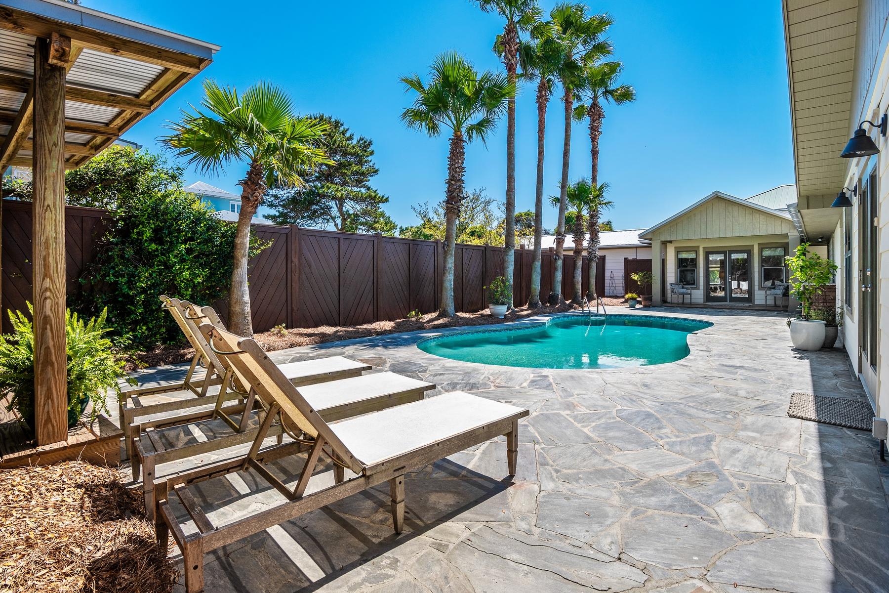 Classic mid-century modern beach cottage with renovations and additions located less than a block to the beach in the sought after community of Crystal Beach. White shiplap walls and beamed ceilings are just a few of the interior features in this remodeled home. Living and entertaining is simplistic with the open floor plan that is centered around a whitewashed brick, gas fireplace. The remodeled kitchen provides a functional layout with casual dining banquet and breakfast bar off the central island. White cabinets, stainless steel appliances including a gas range maintain the light, contemporary look. Tile floors and a farm-style sink deliver stylish touches while leathered granite counter tops finish off the kitchen.