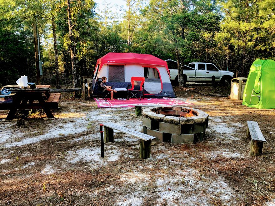 Let's Go Outside! This property is ready to Plug and Play!! Partially cleared, nestled on the creek, and set up to camp, this 1.10 ac lot is ready for your camper or tent. A fire pit, picnic tables, AND ELECTRIC service that is up and running make this a great weekend or summer get away. Permitted for temp RV use, all you need is to plug up your camper or RV and you are GLAMPING.  Deer, coyote, fox, raccoons, armadillos, etc. wildlife in abundance in this very quiet space. Or complete the clearing and build your dream home in the peace and quiet within minutes to Crestview or DeFuniak Springs.