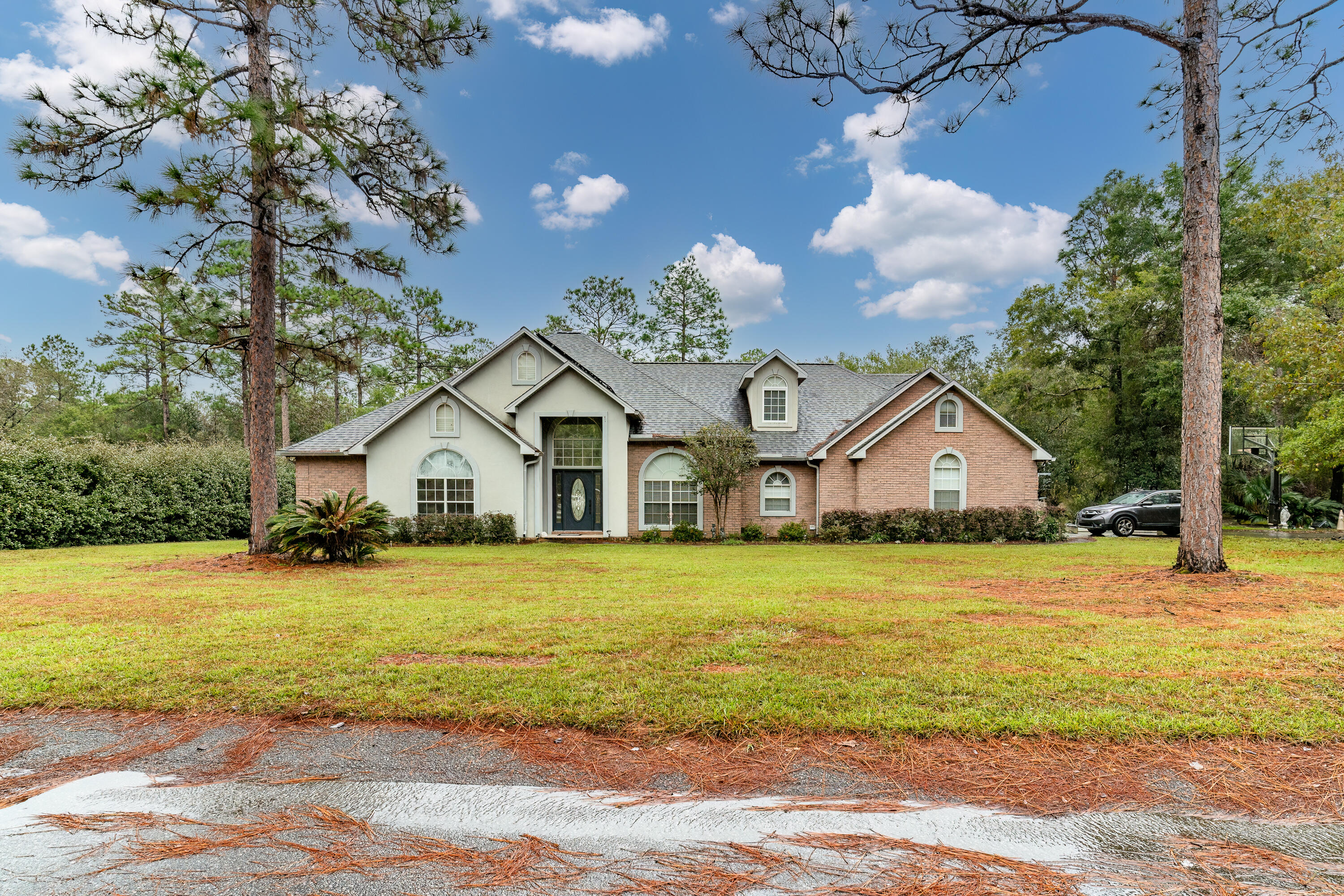 Discover the epitome of luxury living in this stunning 4,000 sq ft brick home nestled on 2 serene acres. This meticulously designed residence offers an abundance of space and comfort, perfect for families of all sizes. Expansive Layout: 7 bedrooms, 3 bathrooms, formal dining room, office, den, living room, Florida room, and a versatile second-level addition. Elegant Interiors: Soaring ceilings, crown molding, and a grand foyer create a sophisticated ambiance. Gourmet Kitchen: A chef's dream with granite countertops, oak cabinets, two pantries, a breakfast bar, and a banquet-sized dining area.  Outdoor Oasis: Enjoy the tranquility of your private backyard featuring a huge deck, open patio, and protected wetlands. Luxurious Master Suite: Indulge in a spa-like retreat with trey ceiling, dual vanities, recessed lighting, a whirlpool tub, a separate shower, and ample closet space. Additional Amenities: A second bathroom with double vanities, a versatile fourth bedroom/office, a cozy den, a second-level family room, and a bonus room. Practical Features: A spacious laundry room with a second pantry and built-in ironing board, a Manibloc plumbing system, and a Renai water heater. Solar panels are paid for and is a 23.63 KW system to help with the electric.  Sprinkler system is not hooked up and being conveyed AS IS.
Conveniently located in Crestview, just 20 minutes from Duke Field and 7th SFG, 30 minutes from Eglin AFB, and 40 minutes from the stunning Emerald Coast beaches. Enjoy the peace and privacy of this secluded estate, while still being within easy reach of essential amenities. Schedule your private tour today.
