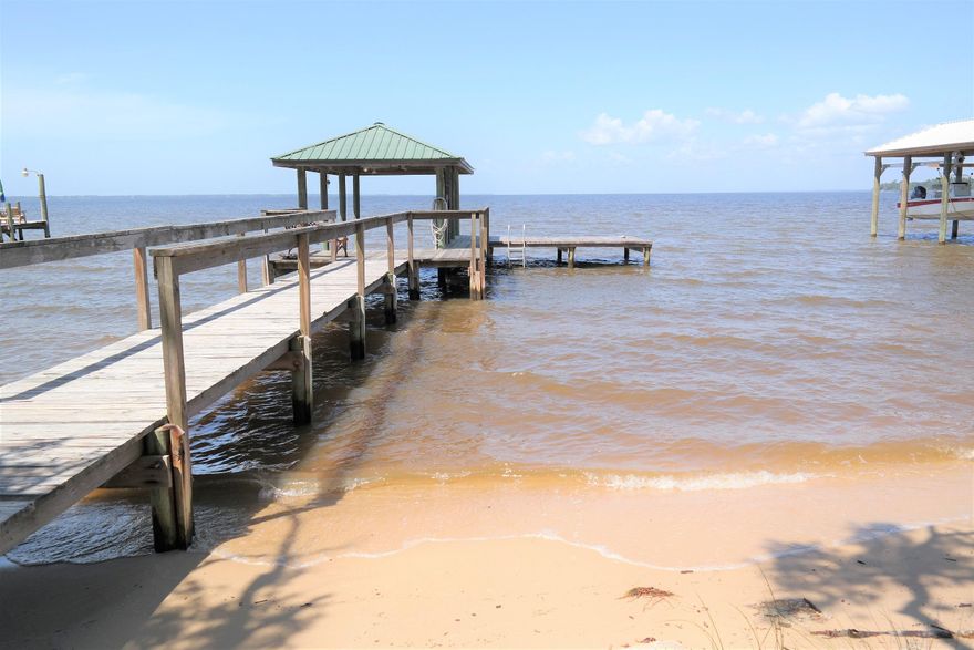 This 3 bedroom, 2 bath bay front home on .62 acres is just North of the Hwy 331 bridge and within 15 minutes of the sandy white beaches of South Walton County. 83 ft. of bay frontage; your own private dock with boat lift. Walk right out into the bay from the beautiful sandy shore in your own back yard! This is an older home in need of some updating, but with a little TLC, could be turned into your dream home or perfect vacation getaway. Schedule your showing today! The dock did sustain some damage in Hurricane Nate in Oct. of this year.