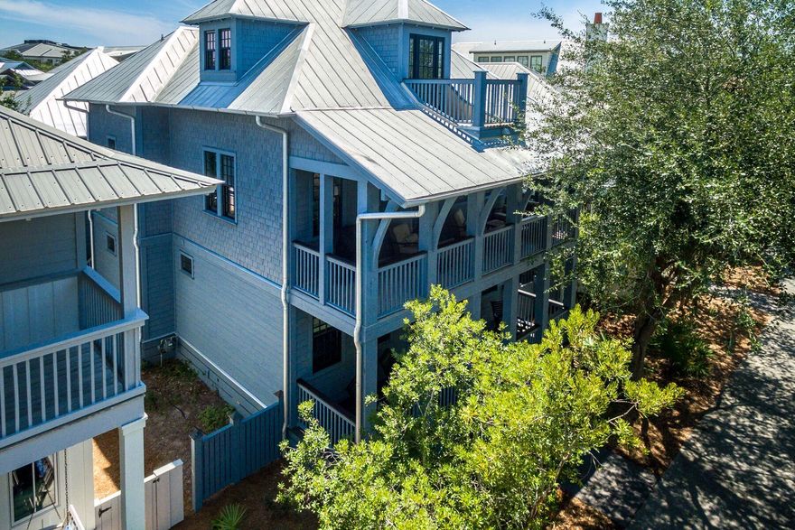 Tucked away on West Water Street in the heart of Rosemary Beach, this three-story home with a detached carriage house placed over a two-car garage has never been rented and overlooks the Cabana Pool and Park. Offering four bedrooms with four and a half baths, this 2,907 square foot home greets you with a spacious covered front porch and rockers arranged for conversation. You will find beautiful wood floors throughout the home and an additional living room on the main level, as well as, a coveted main floor master suite and an expansive guest room with an attached bath that is also accessible from the living area. The master suite boasts a spacious bathroom with dual vanities and a glass shower. The home's great room is situated on the second level and offers an expansive living room, open