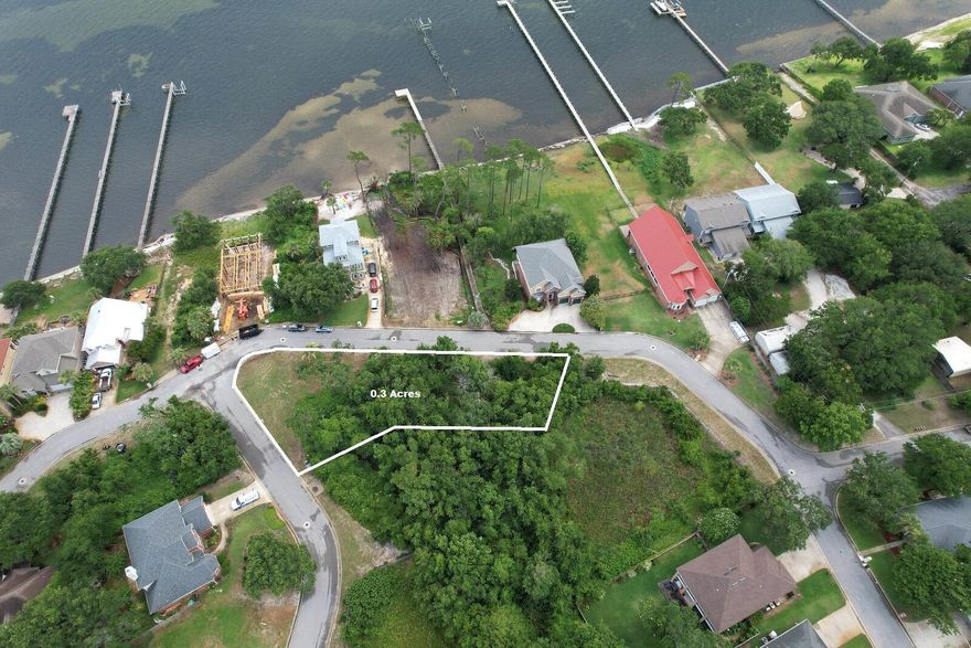 Perfect water view homesite across from the sound in beautiful Navarre Beach. This vacant lot is tucked away in the secluded and desired neighborhood of Magnolia Harbor and just minutes away from the world famous attractions of Navarre Beach and the gorgeous sparkling sands of the Emerald Coast fronting the Gulf of Mexico. Navarre is centrally located halfway between Pensacola (the seat of Naval Aviation) to the west and Destin (world's luckiest fishing village) to the east. Quick access to prominent military bases of Eglin AFB, Hurlburt Field, and NAS Pensacola. Convenient to shopping at Publix, Walmart, Winn Dixie and dining at popular local eateries like Dewey Destin's and many others. Neighborhood has code access private community dock. This prime gem will not last long.