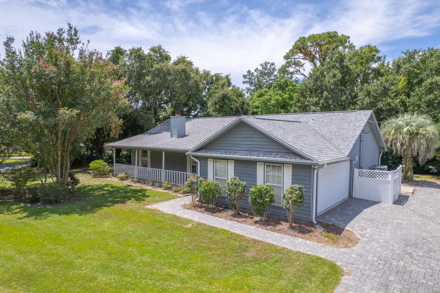 Offered FULLY FURNISHED, this property is move-in ready and an incredible opportunity as either a primary residence or an Airbnb investment! Rental projections are coming in at $39,000 annually.. Located in the sought-after neighborhood of Villa Venyce in the heart of Gulf Breeze, this charming home offers the perfect blend of comfort, style, and convenience. Enjoy access to the neighborhood park, complete with a playground, pavilion, tennis courts, and pickleball courts all while being just moments from top-rated schools. Situated on a shaded corner lot, the curb appeal shines with a paver driveway, mature trees and landscaping, and a welcoming covered front porch. Inside, the open floor plan is enhanced by new luxury vinyl plank flooring throughout and a freshly updated kitchen. The liv ing room boasts vaulted ceilings, skylights, and a striking stone wood-burning fireplace. Updates in the kitchen include newly painted cabinets equipped with new hardware, new appliances, a coastal-inspired backsplash, quartz countertops, an added island, and a new sink! The dining area sits just off the kitchen, with French doors that open directly into the sunroom, creating an easy flow for entertaining. Just off the sunroom are multiple back decks and a hot tub! The split primary suite includes private deck and hot tub access through french doors, plus an en suite bathroom with double vanities, a tub/shower combo, and a large walk-in closet. Two additional bedrooms are located on the opposite side of the home, with a full bathroom in between. One bedroom also opens directly to a 12x16 screened porch, ideal for relaxing in the shade. With its versatile layout, multiple outdoor living areas, and prime location on a quiet street, this home is ready for its next owner to enjoy the best of Gulf Breeze living!