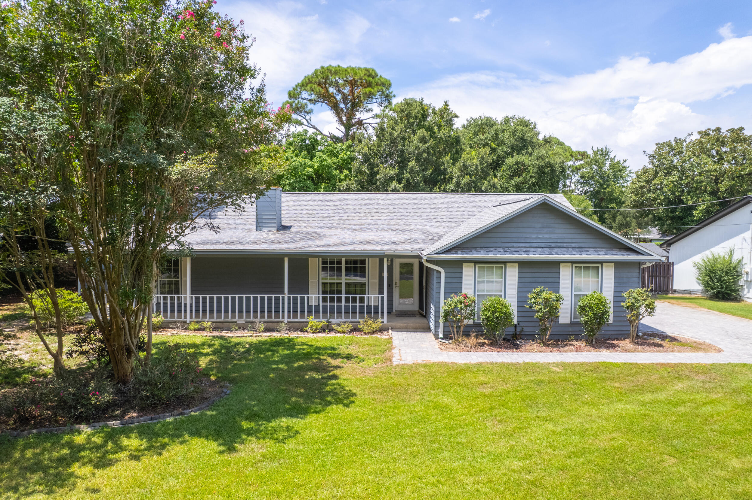 Offered FULLY FURNISHED, this property is move-in ready and an incredible opportunity as either a primary residence or an Airbnb investment! Rental projections are coming in at $39,000 annually.. Located in the sought-after neighborhood of Villa Venyce in the heart of Gulf Breeze, this charming home offers the perfect blend of comfort, style, and convenience. Enjoy access to the neighborhood park, complete with a playground, pavilion, tennis courts, and pickleball courts all while being just moments from top-rated schools. Situated on a shaded corner lot, the curb appeal shines with a paver driveway, mature trees and landscaping, and a welcoming covered front porch. Inside, the open floor plan is enhanced by new luxury vinyl plank flooring throughout and a freshly updated kitchen. The liv ing room boasts vaulted ceilings, skylights, and a striking stone wood-burning fireplace. Updates in the kitchen include newly painted cabinets equipped with new hardware, new appliances, a coastal-inspired backsplash, quartz countertops, an added island, and a new sink! The dining area sits just off the kitchen, with French doors that open directly into the sunroom, creating an easy flow for entertaining. Just off the sunroom are multiple back decks and a hot tub! The split primary suite includes private deck and hot tub access through french doors, plus an en suite bathroom with double vanities, a tub/shower combo, and a large walk-in closet. Two additional bedrooms are located on the opposite side of the home, with a full bathroom in between. One bedroom also opens directly to a 12x16 screened porch, ideal for relaxing in the shade. With its versatile layout, multiple outdoor living areas, and prime location on a quiet street, this home is ready for its next owner to enjoy the best of Gulf Breeze living!