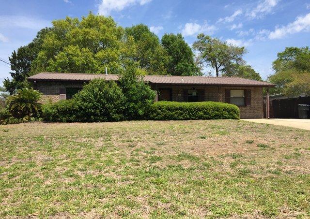 REO ~ Older Home w/ Lots of Potential. This 3 bedroom, 1 bath home offers plenty of living space with a formal living & dining area, den with fireplace as well as a Florida Room. The back yard offers an in-ground pool & separate structure, which could be used as a cabana or storage room.