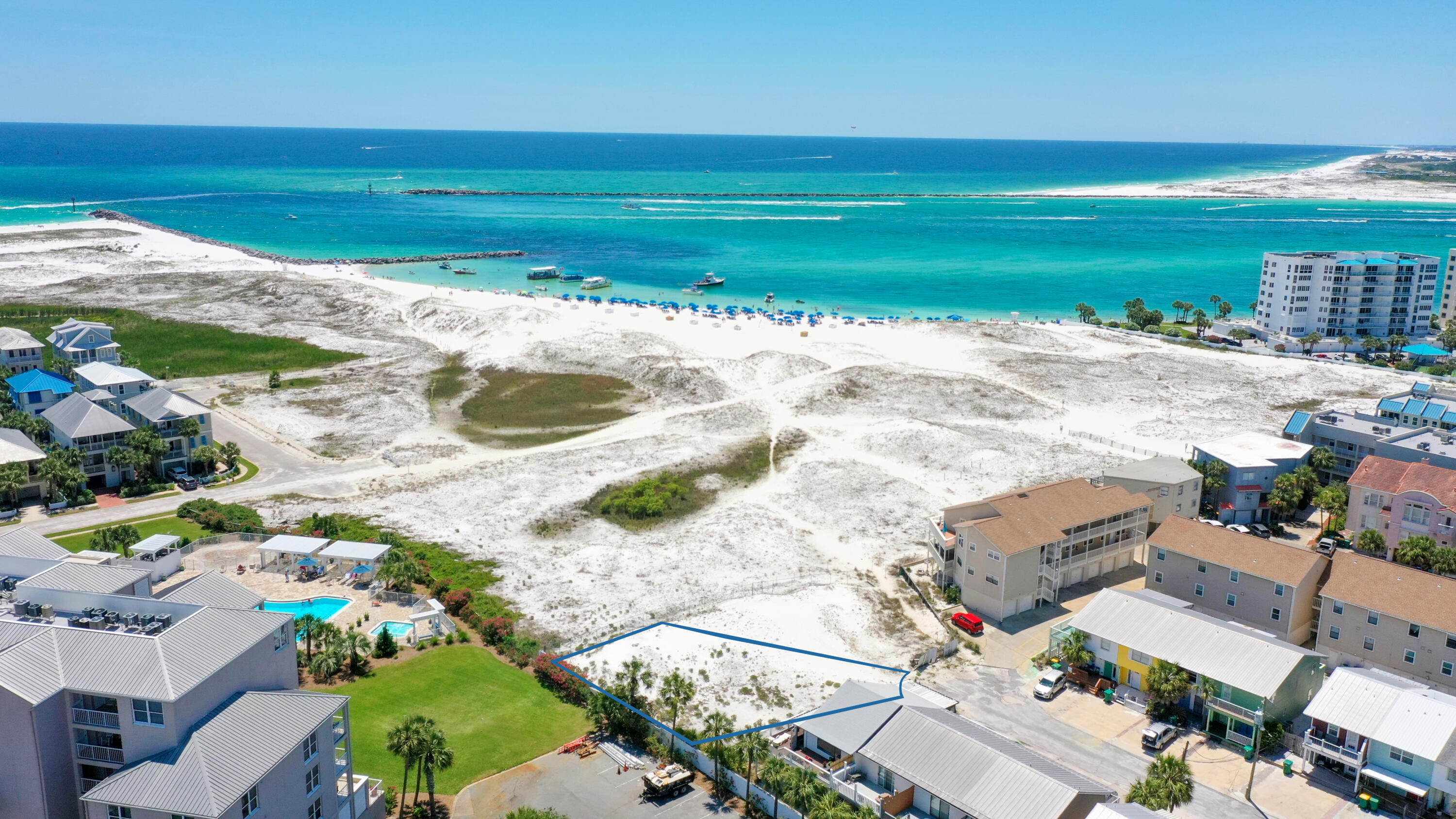 Build your dream home or investment property on this rare coastal plot! The lot conveys with a set of plans designed specifically for this location: a beach house that has three stories and 3136 sqft of heated & cooled space and 2844 sqft of outdoor decks. This home has 3 bedrooms & 3.5 baths and a spacious roof deck. Located on desirable Holiday Isle in the heart of Destin and less than 1/4 mile from the water, a constant sea breeze is the hallmark of the environs. Enjoy beautiful panoramic Gulf and East Pass views in the distance. The lot is at the end of Gulf Breeze Court offering quiet coastal living. Take a boat taxi across the Harbor and enjoy the entertainment and restaurants at Harborwalk Village or along Harbor Boulevard in downtown Destin. Create your perfect paradise!