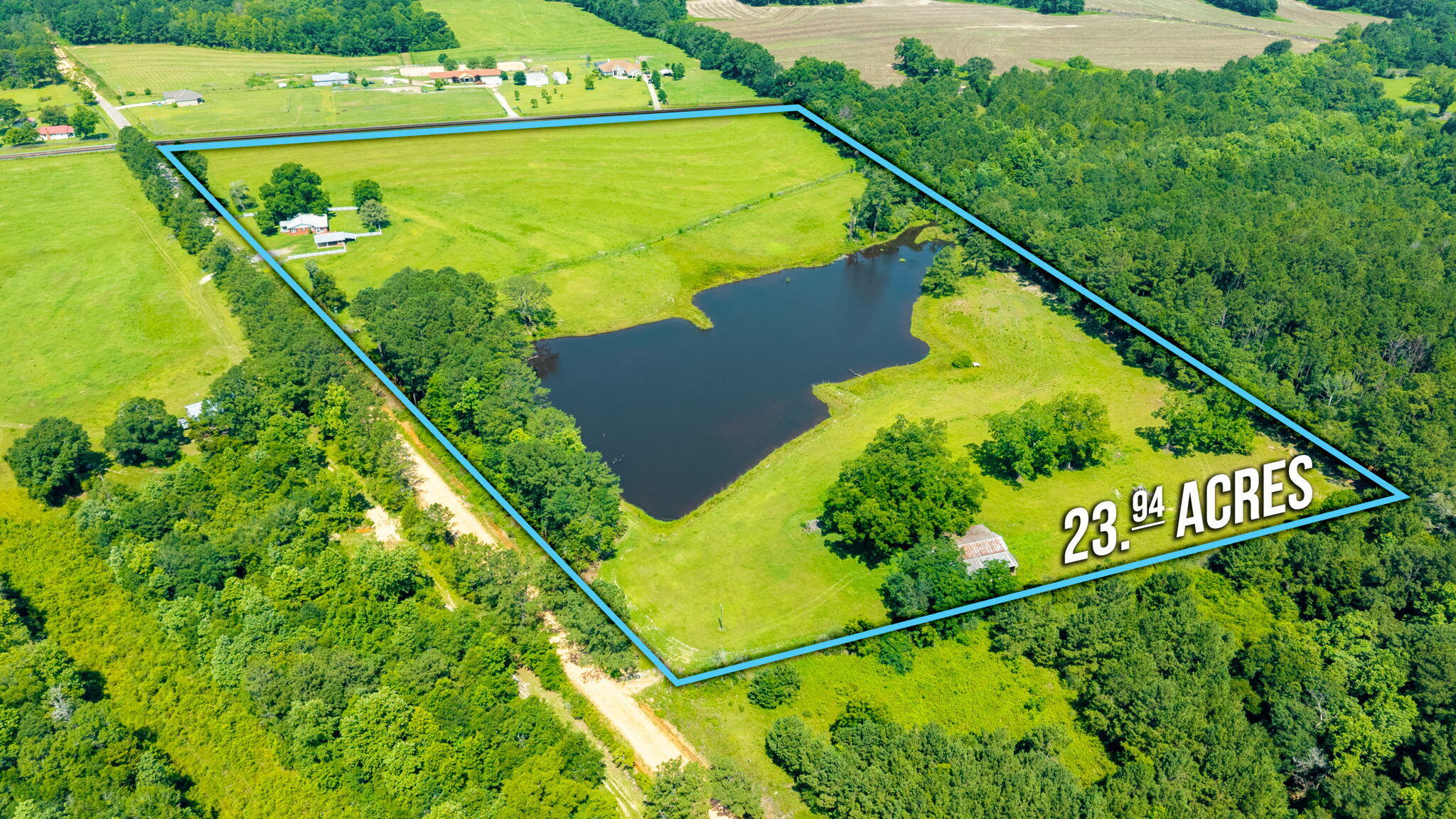 24 ACRES OF PRISTINE ROLLING PASTURELAND - OVERLOOKS A STOCKED (and in need of fishing) SEVEN ACRE LAKE that is just as absolutely gorgeous, as gorgeous private lakes go! There is also a VERY LARGE 50X60 POLE BARN in addition to the 1800 SF existing brick home. Lots of original pine hardwood walls and original hardwood flooring too. It could be fixed up really rustic. This property is also perfect for a multiple home family compound, a church retreat and campground, or for the perfect single hilltop homesite with that incredible pastureland lakeview (and guest house the existing home). Two car carport with storage rooms, side porch and brick patio. Plenty of fencing to keep horses, cows, kids and dogs in. Sale subject to final probate-call to see today.