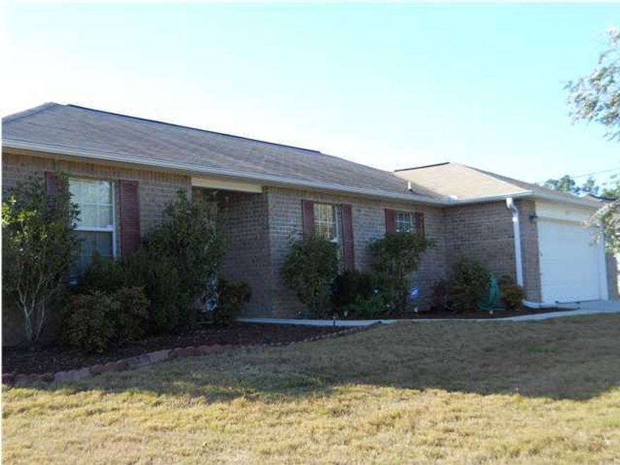 This is an all brick 3BR/2BA home, split bedroom floor plan with a screened in porch and a small patio. The living features cathedral ceilings with remote control fan. The sliding glass doors lead to the screened porch with a ceiling fan. Wood laminate floors in living, dining, and hallways of home. The kitchen has plenty of cabinet space, a pantry for food storage, refrigerator and dishwasher. There is also a small eat-in area. A separate dining room. Both guest bedrooms have ceiling fans. The hall bath has a vanity with storage, medicine cabinet and linen closet. The master bedroom and bath is separate from the living area. The master bath has two walk-in closets, a separate shower, garden tub, and double vanity. The two car garage has attic storage and is equipped with auto opener.